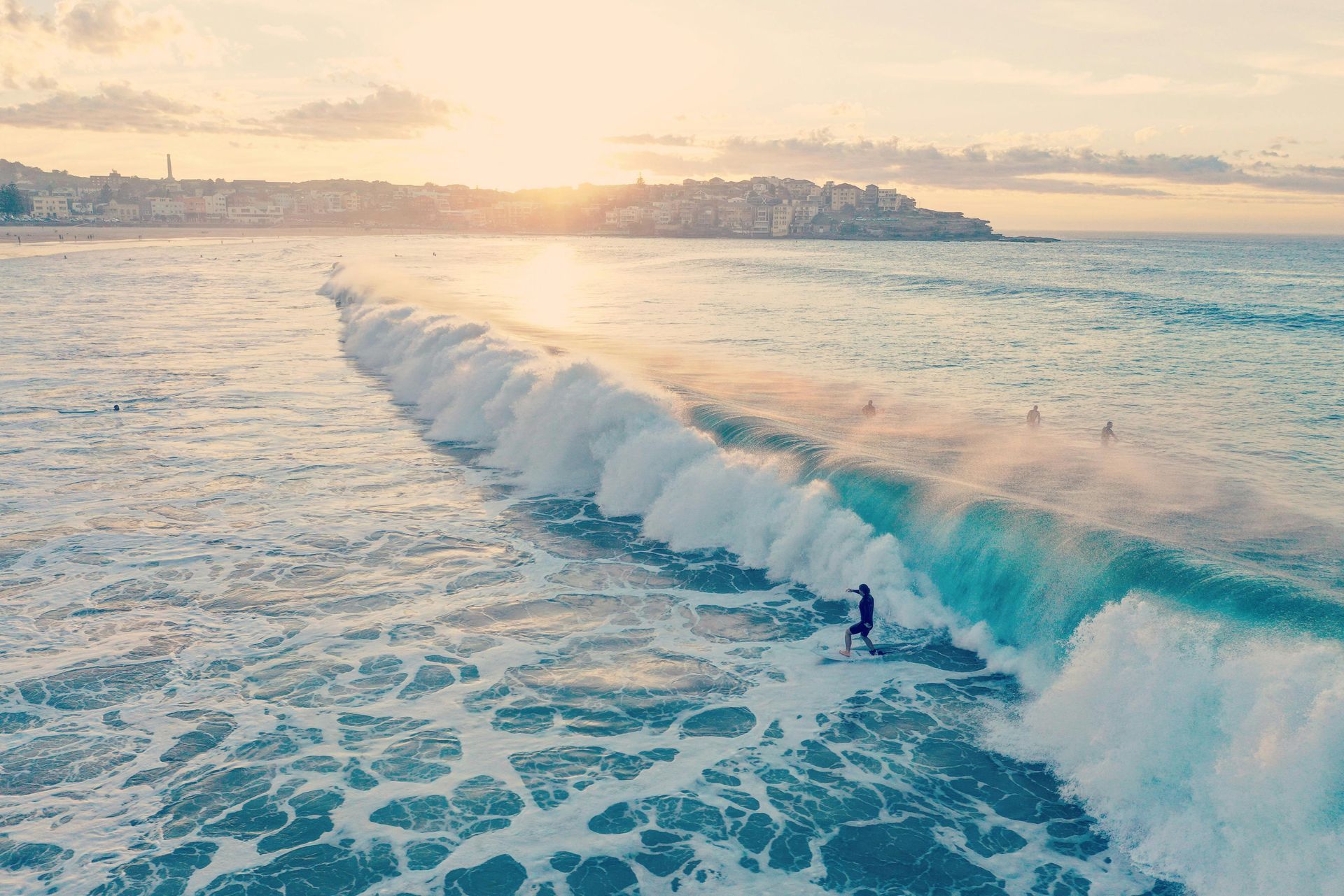 A man is riding a wave on a surfboard in the ocean in Australia.