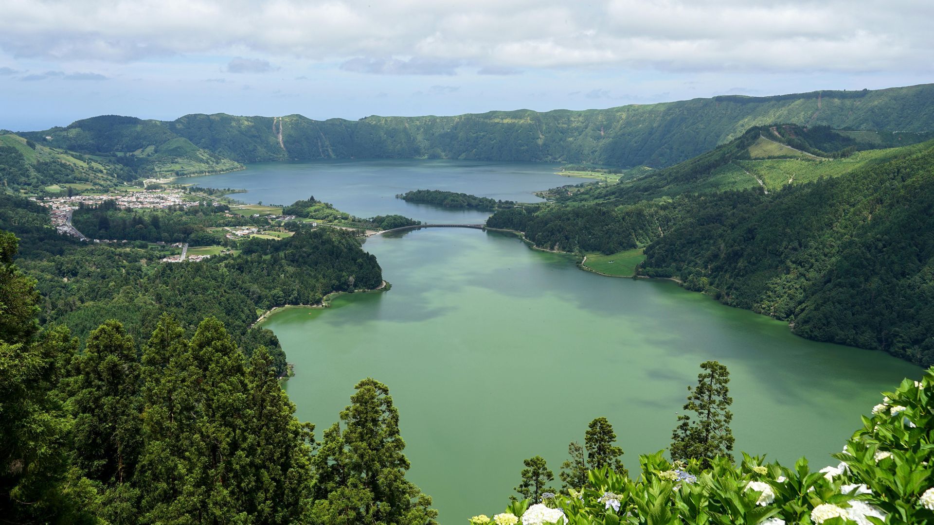 A large lake surrounded by mountains and trees on the Cook Islands.