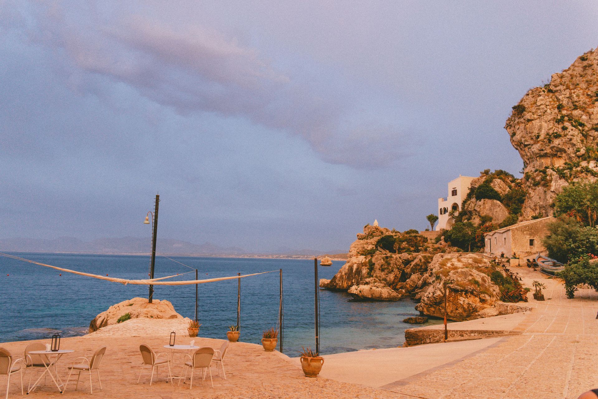 A beach with a volleyball net in the middle of it in Sicily, Italy.