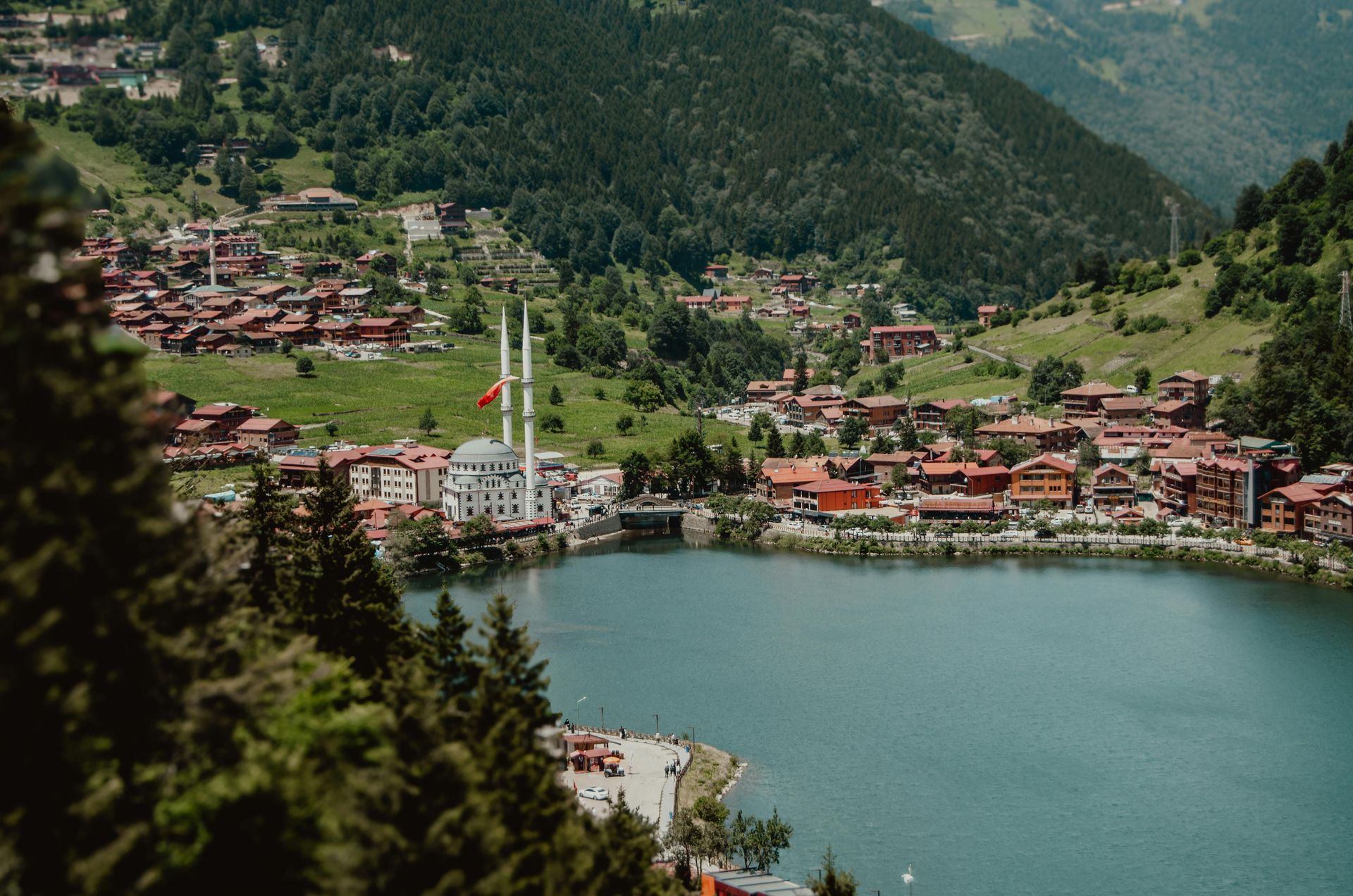 An aerial view of a small town next to a lake surrounded by mountains in Switzerland.