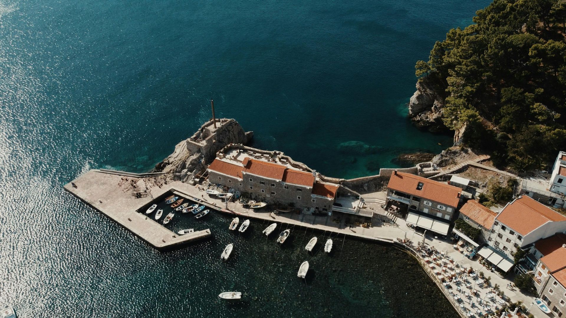 An aerial view of a small town in the middle of the Mediterranean ocean.