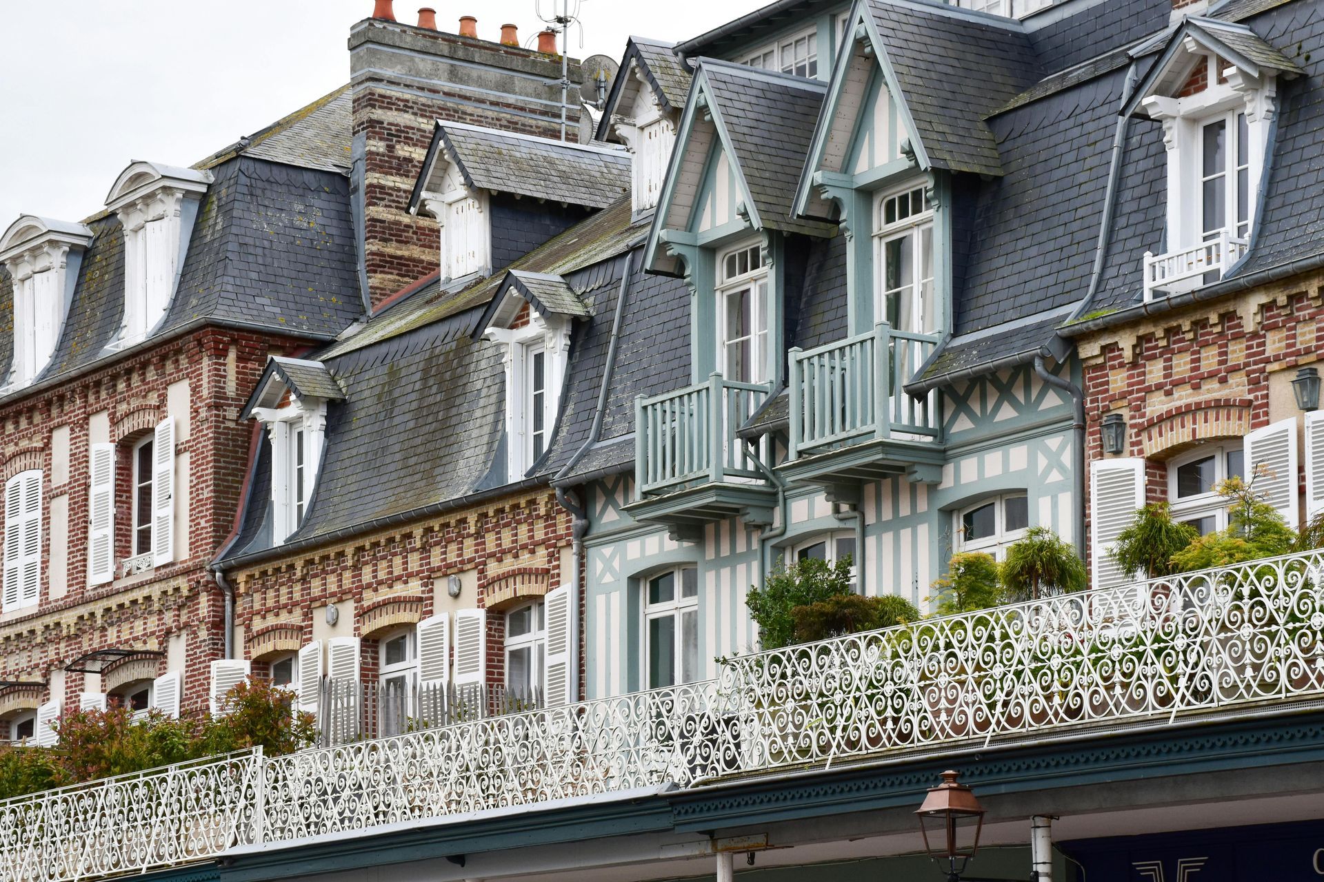 A row of houses with balconies and shutters on the windows in Normandy France.