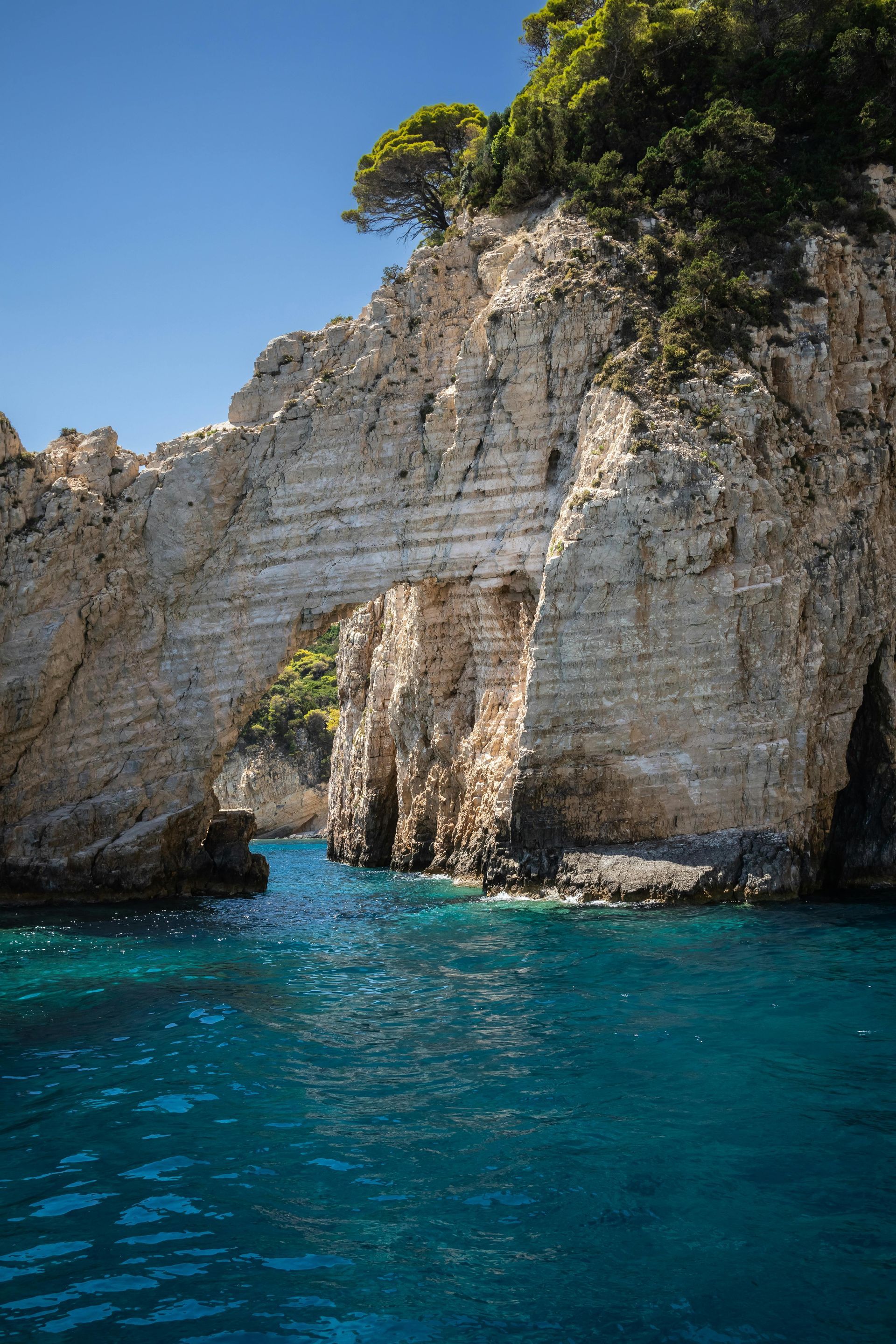 A large rock formation in the middle of a body of water in Zakynthos, Greece.