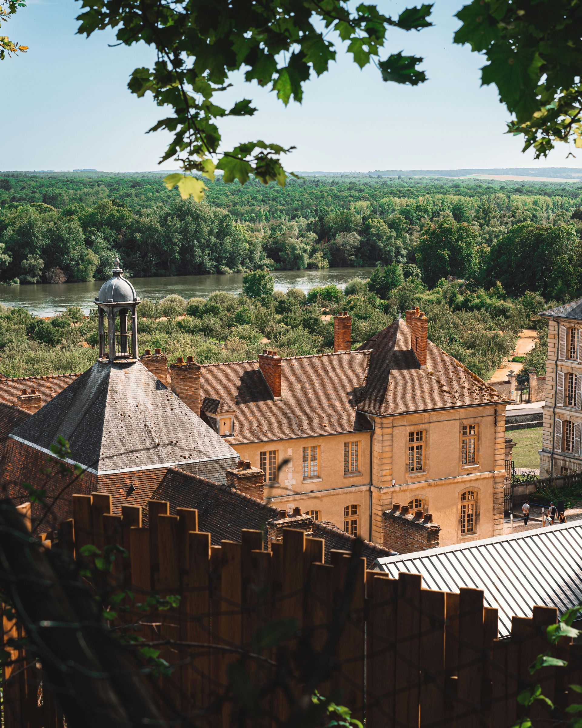 A view of Champagne, France with a wooden fence in the foreground.