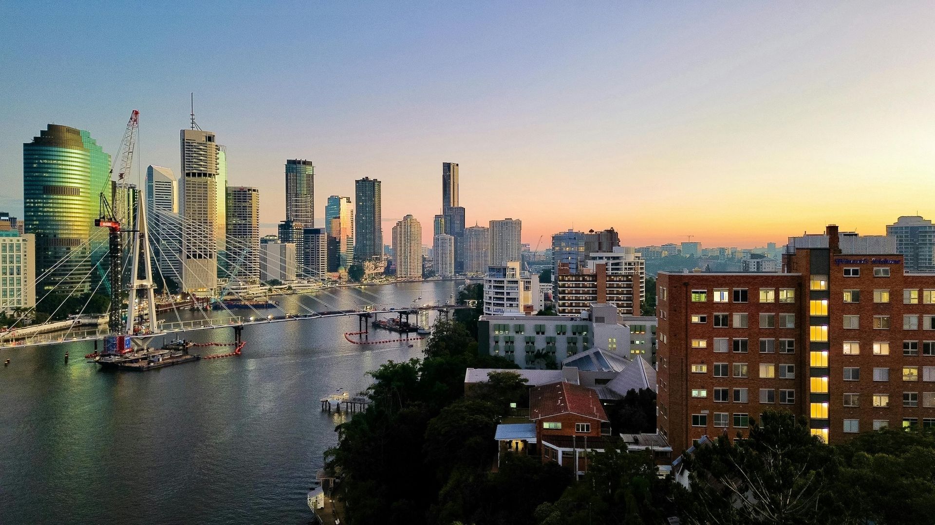 A city skyline with a river in the foreground in Australia. 