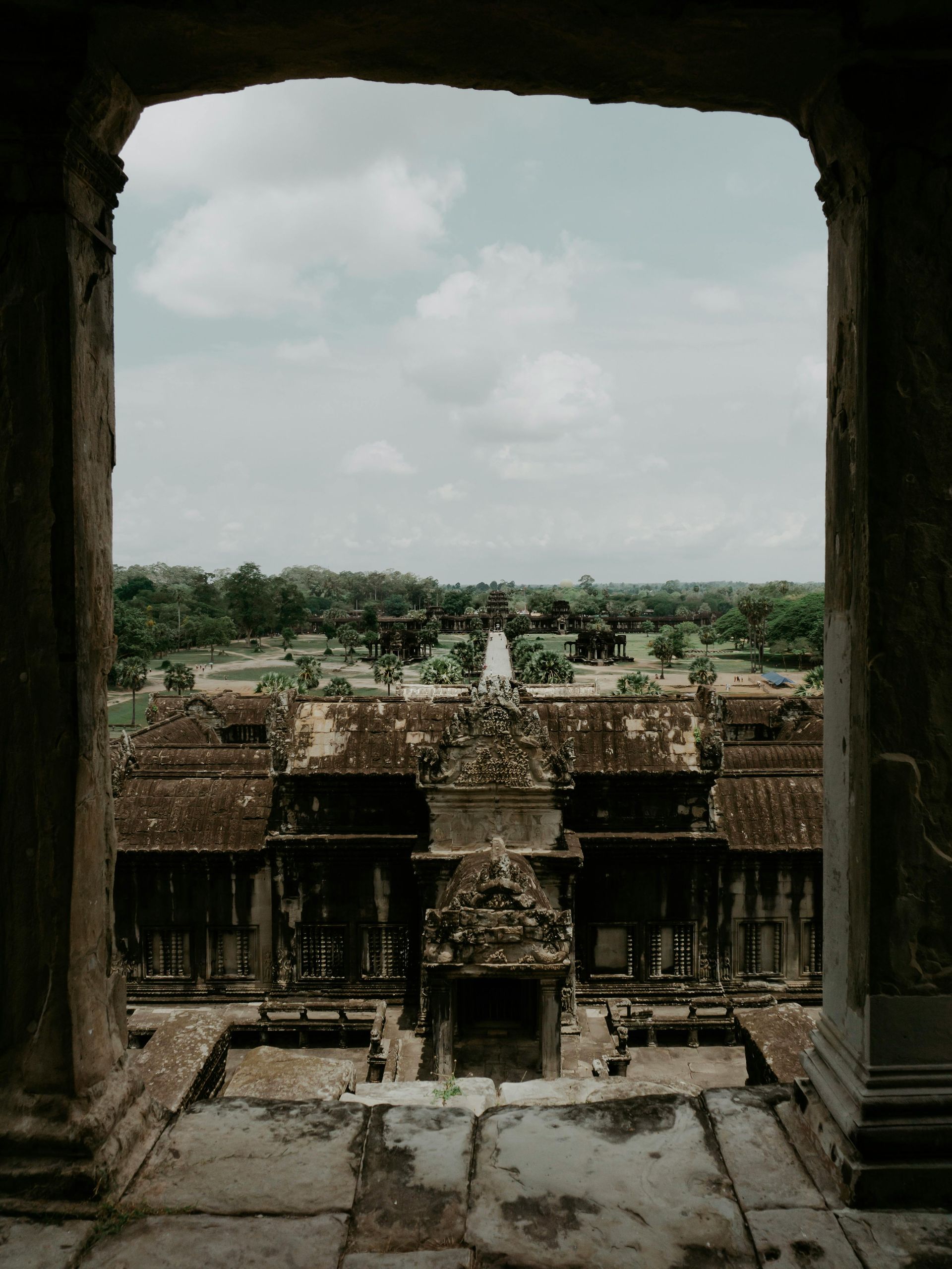 A view of a temple through a stone archway in Cambodia.