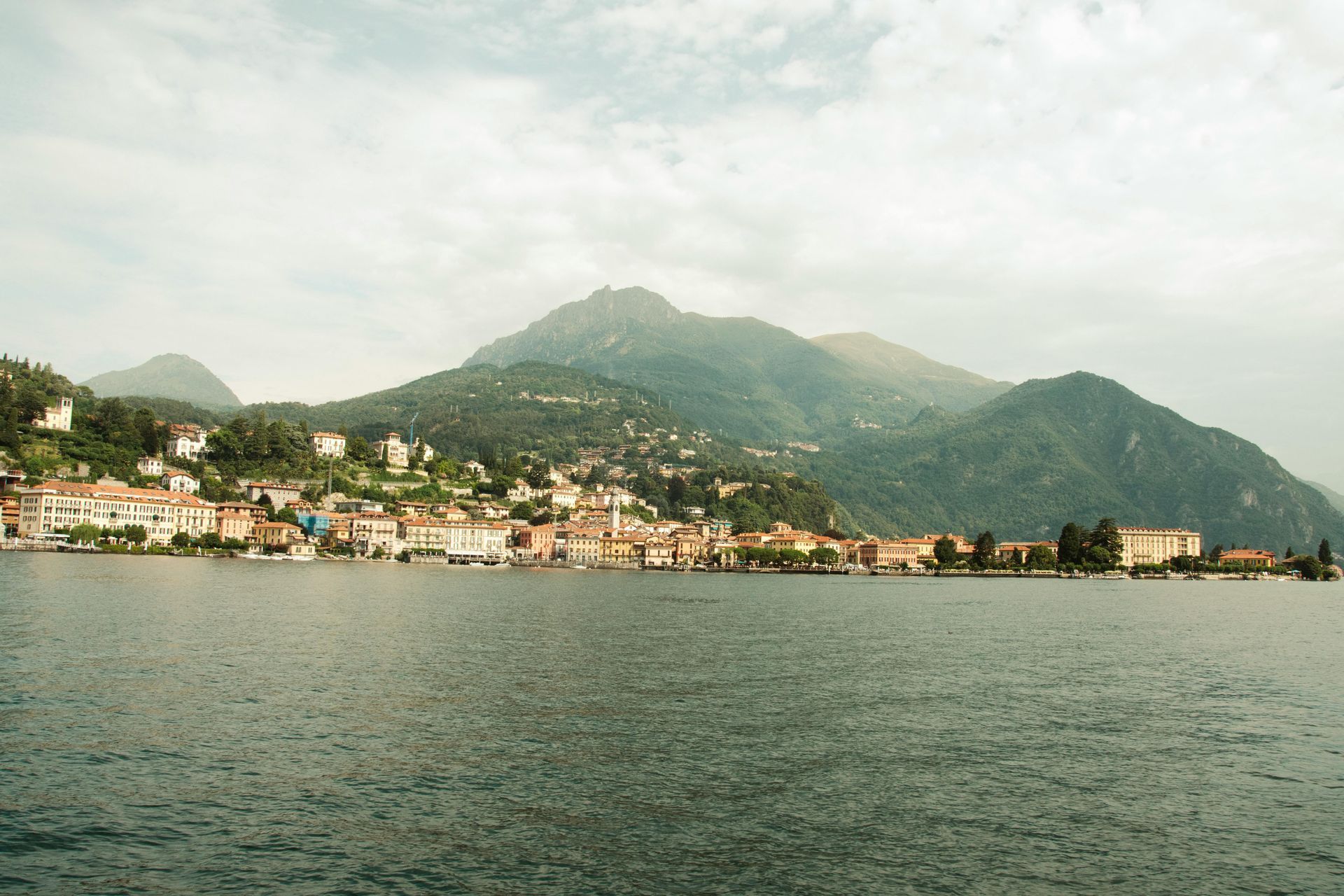 Lake Como with mountains in the background and houses on the shore in Italy.