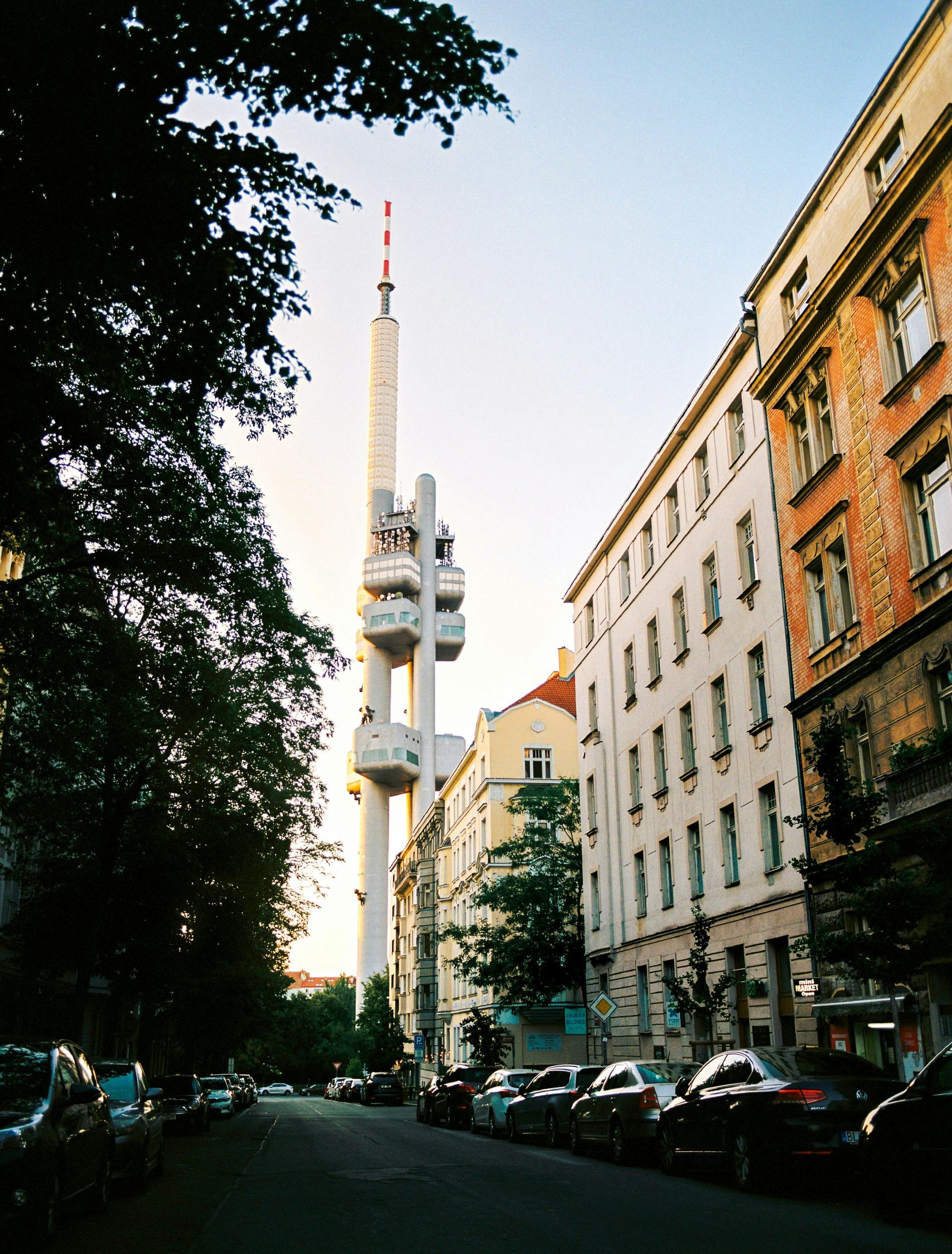 A city street with Žižkov Television Tower in the background in Prague. 