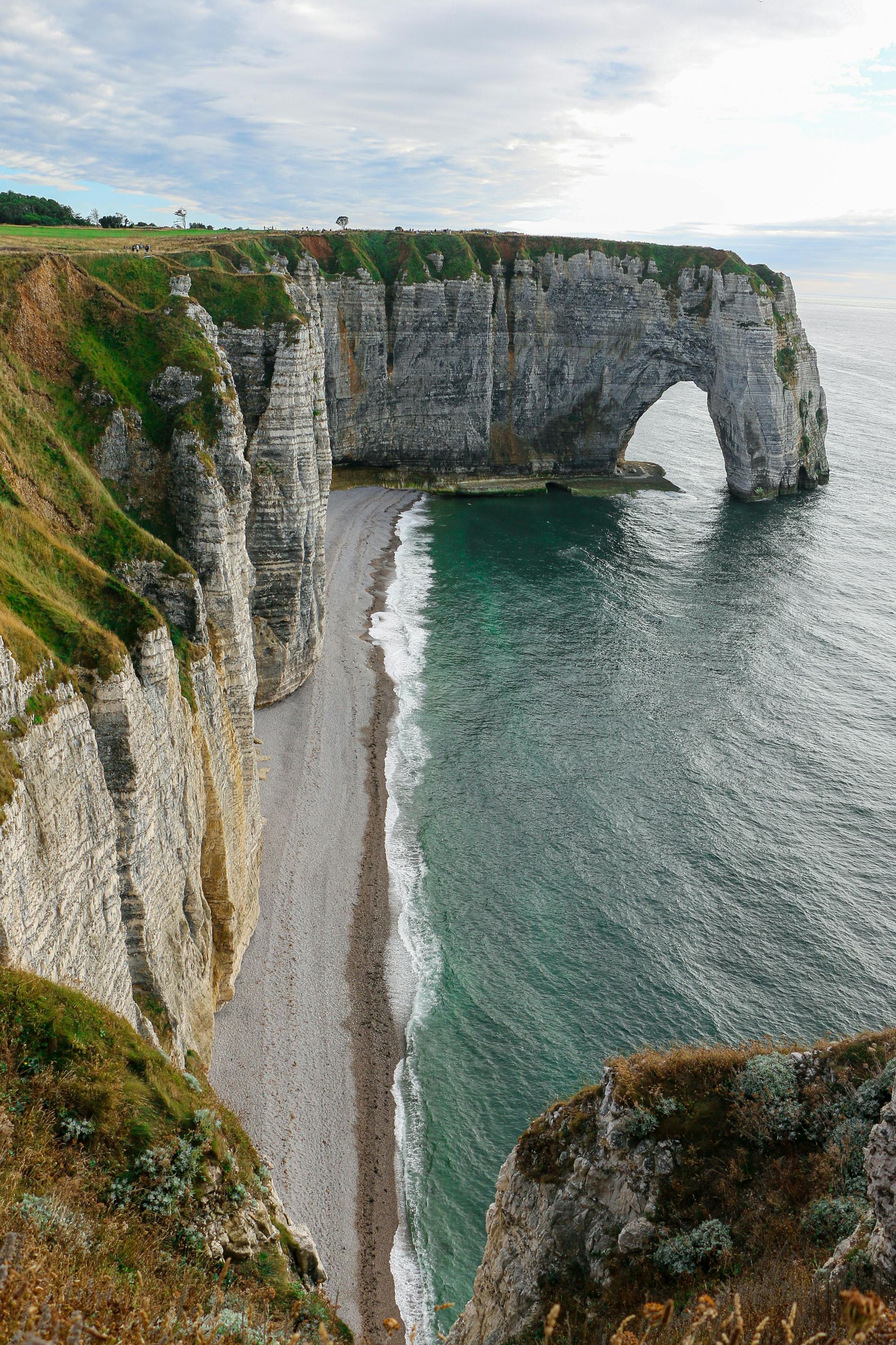 There is a large rock formation named Étretat in the middle of the ocean in Normandy, France.