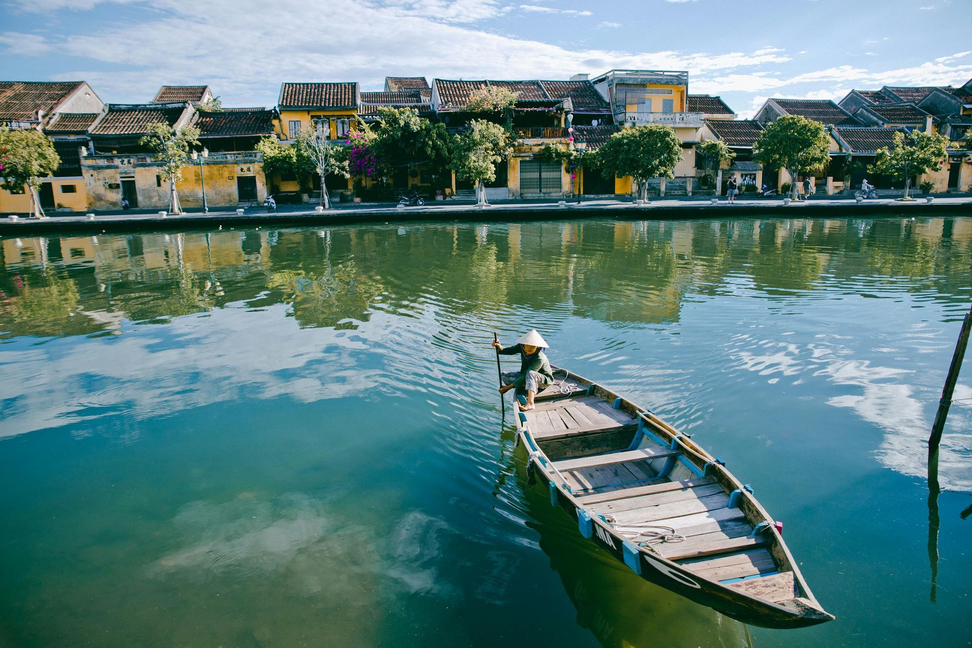 A wooden boat is floating on top of a body of water in Vietnam.