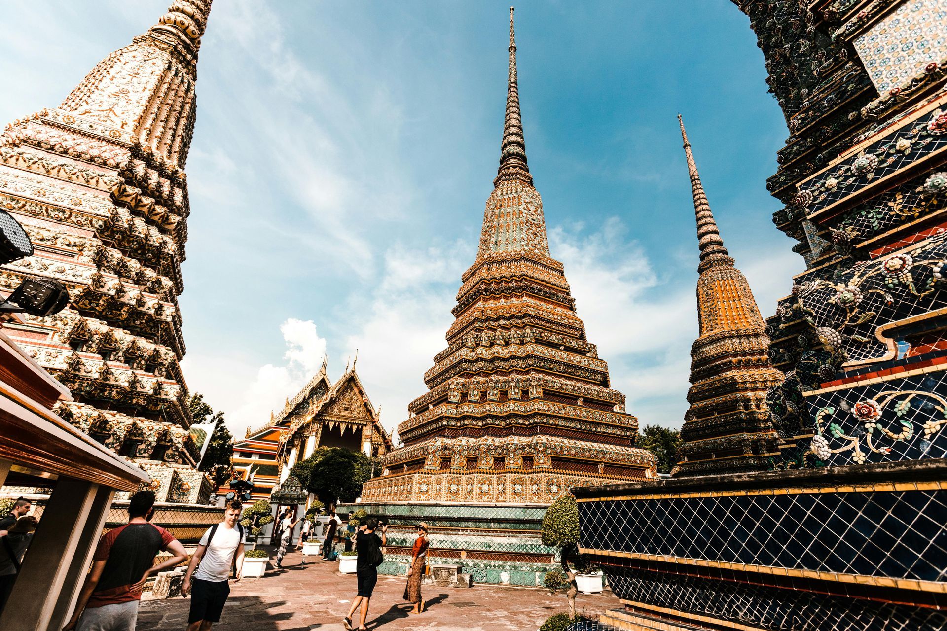 A group of people are standing in front of a temple in Thailand.