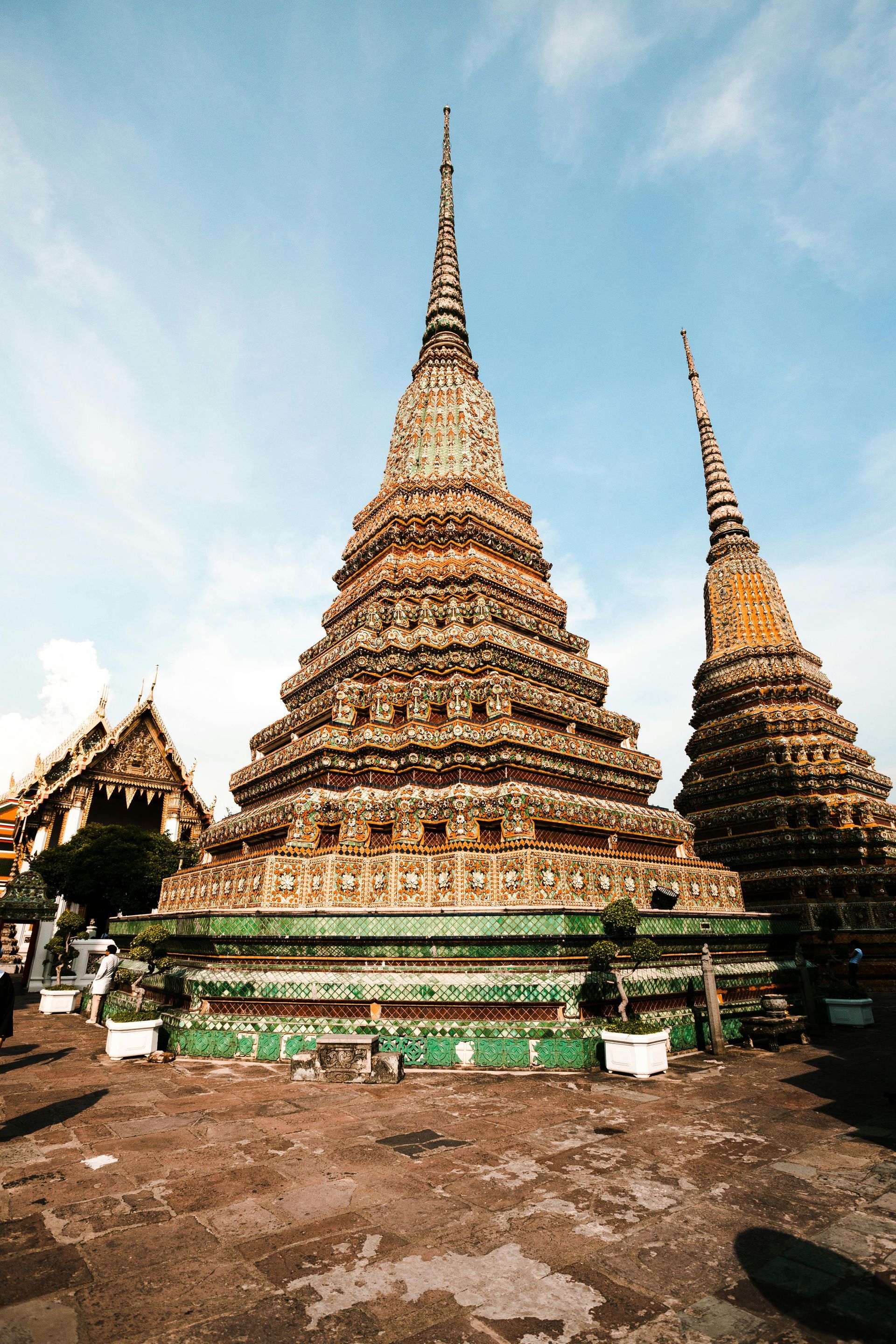 A very tall temple with a blue sky in the background in Bangkok, Thailand.