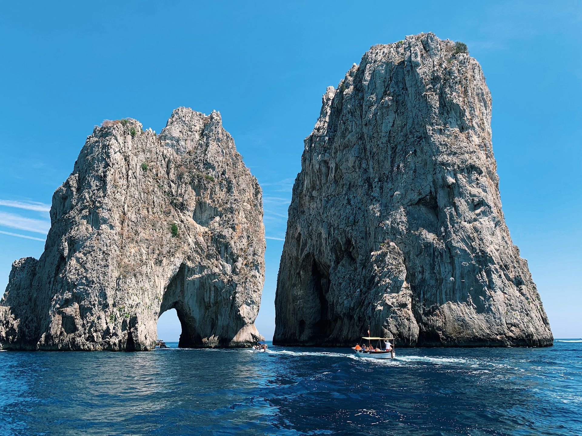 Two large rocks in the middle of a body of water in the Amalfi Coast, Italy