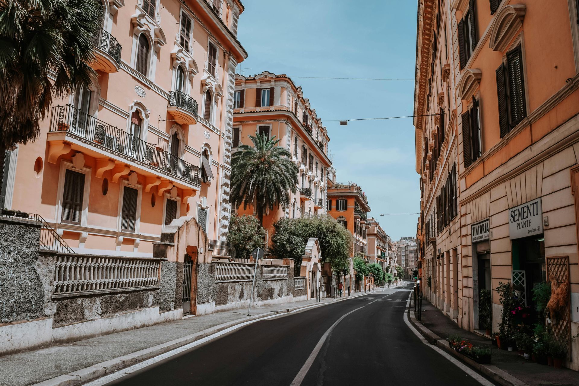 An empty street with a lot of buildings on both sides in Rome, Italy.