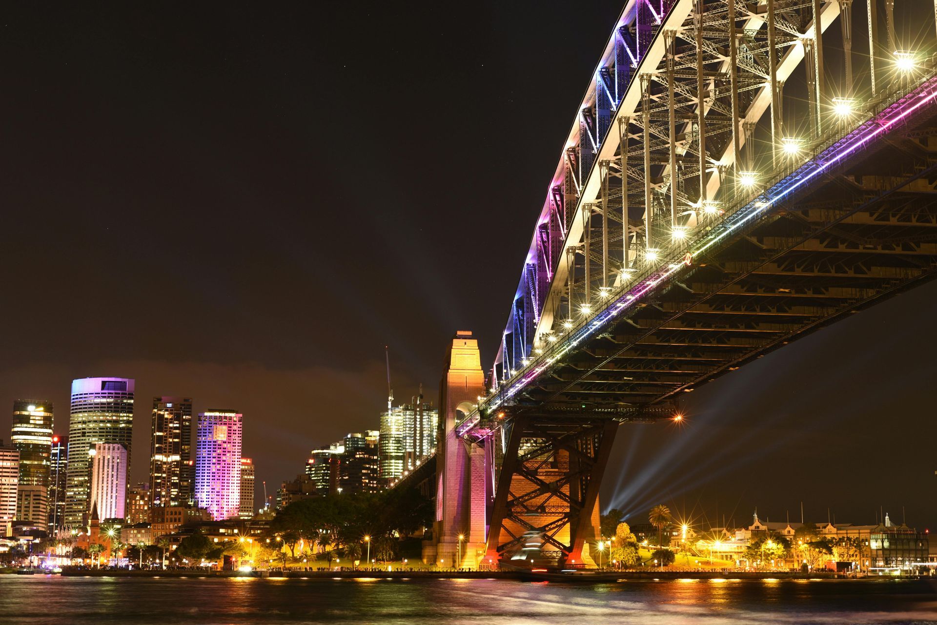 The Sydney harbor bridge is lit up at night in Australia.