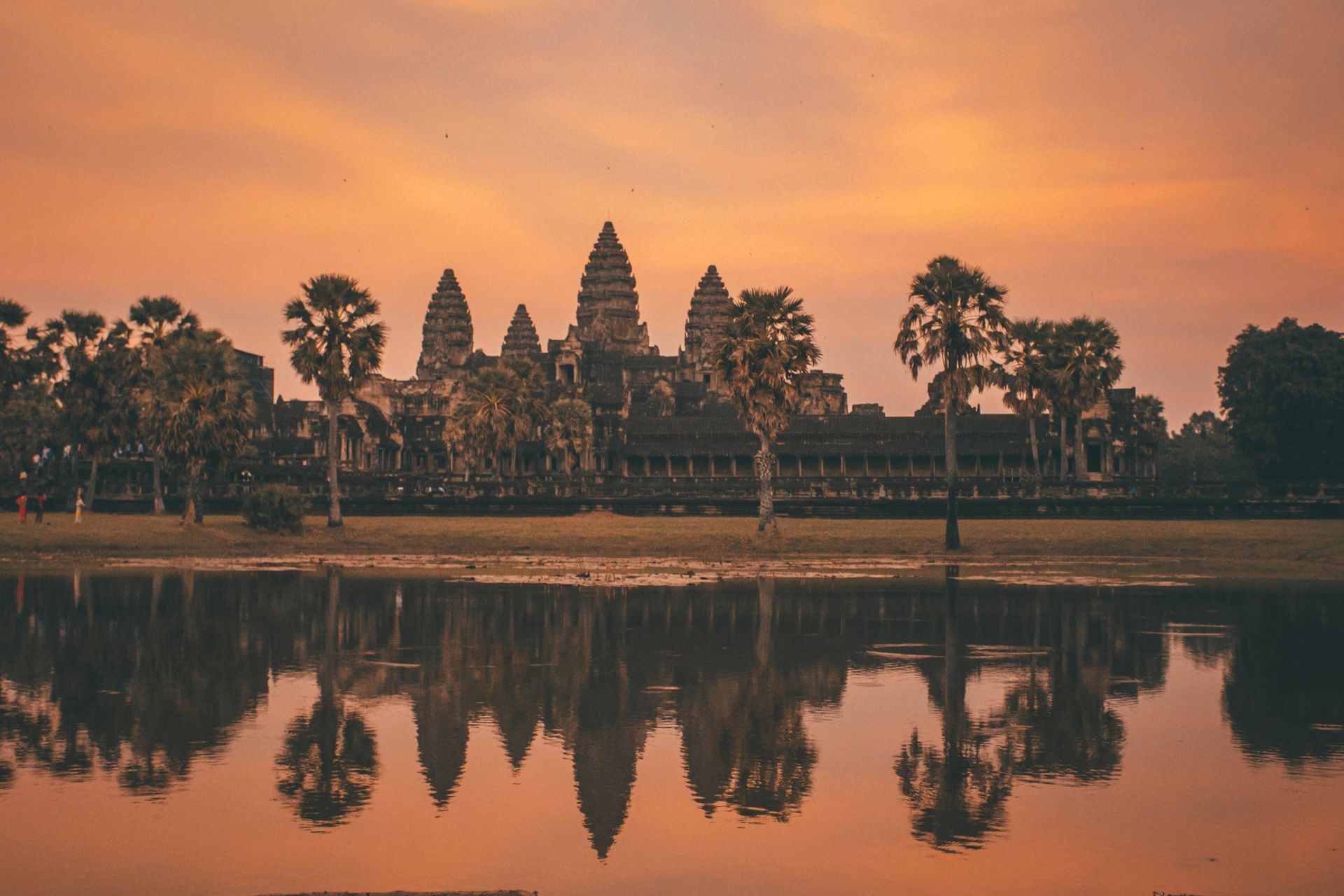  Banyon Temple in Angkor Wat is reflected in the water at sunset in Cambodia.