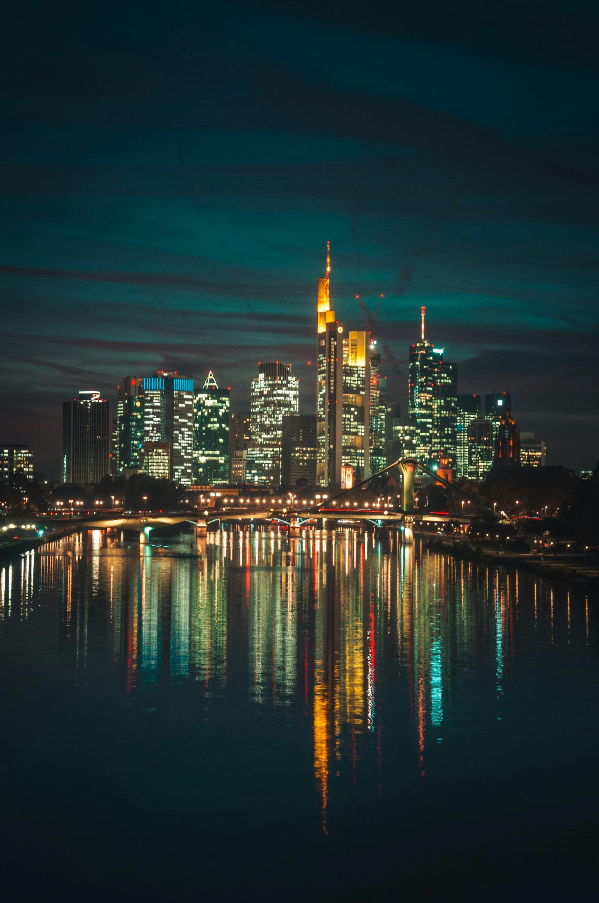 Frankfurt skyline at night with the river Main in the foreground in Germany. 