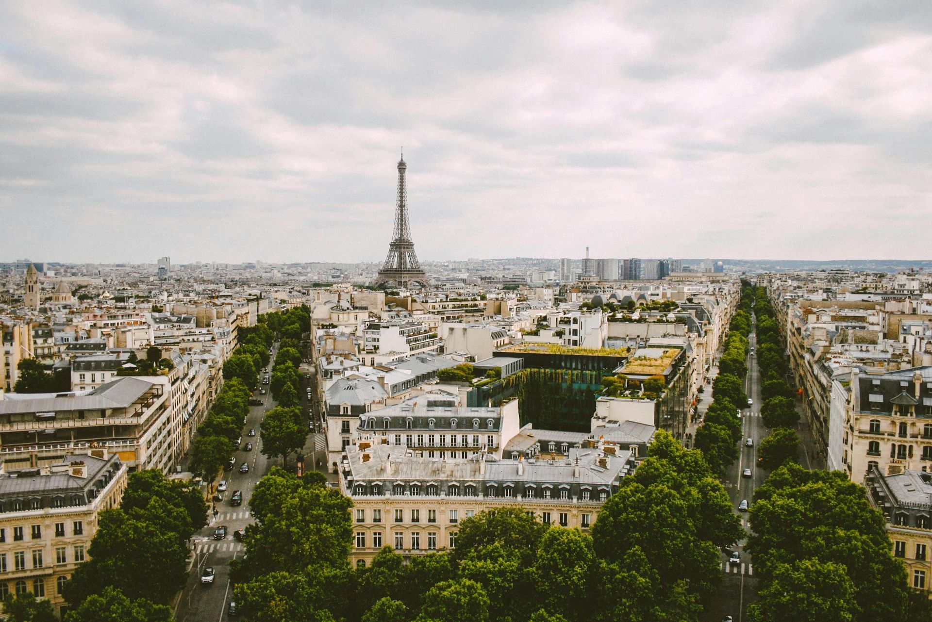 An aerial view of paris with the eiffel tower in the background.