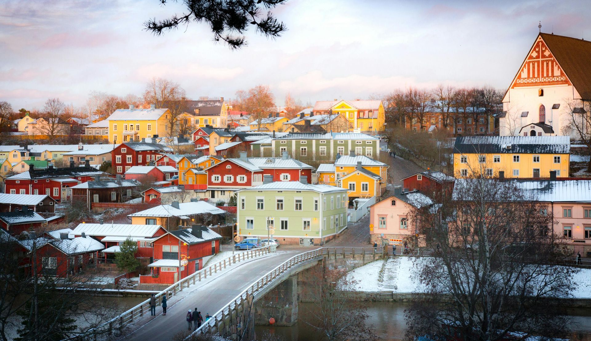 A snowy city with a bridge and a castle in the background in Finland.