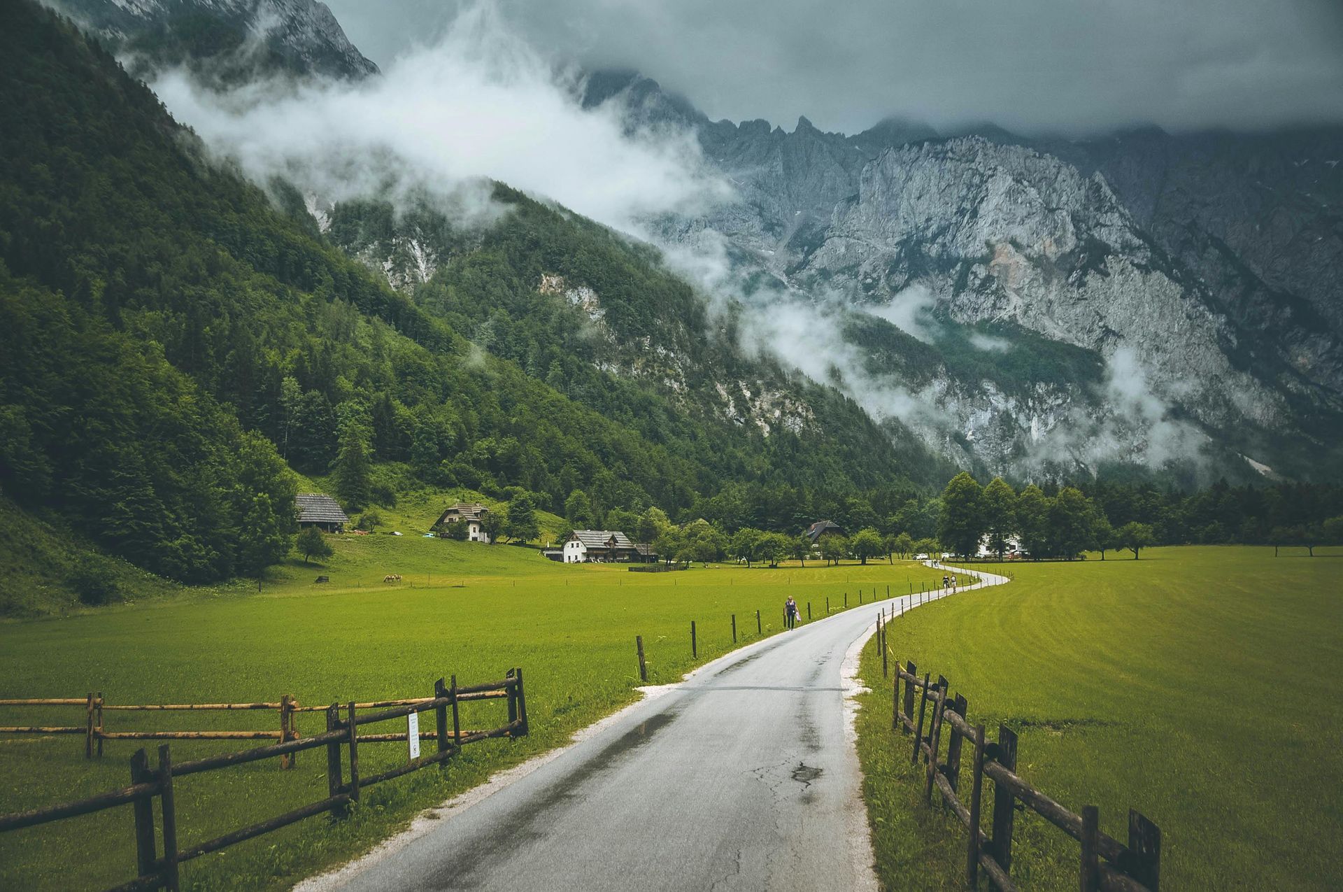 A road going through Logar Valley
with mountains in the background in Slovenia. 