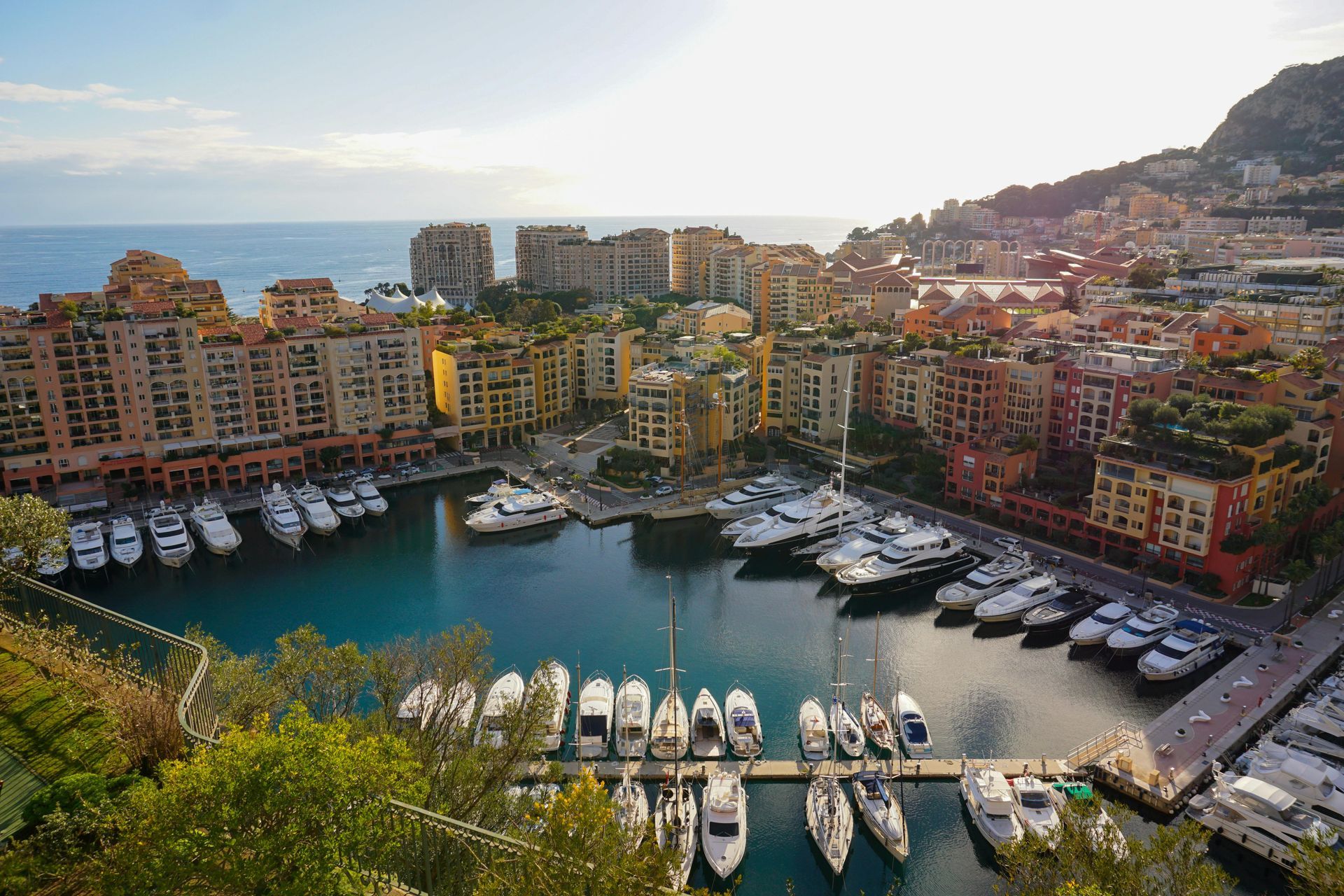 An aerial view of a city with boats docked in the harbor Port Hercule in Monaco.