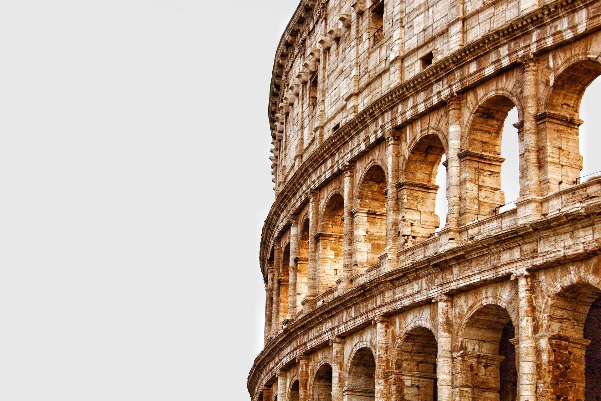 The colosseum in rome is a large stone building with arches and columns in Italy.