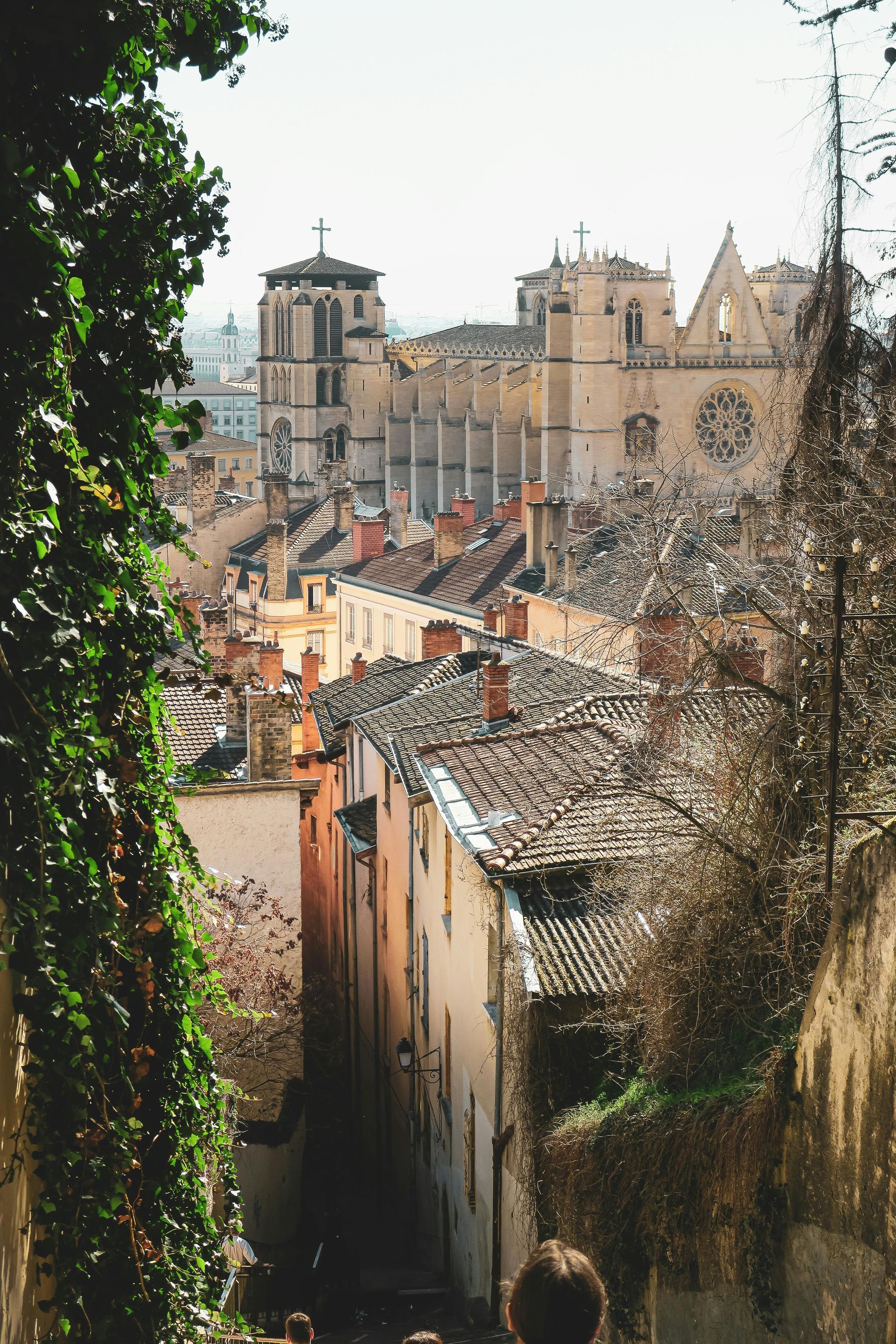 A view of a Lyon, France with a clock tower in the background.