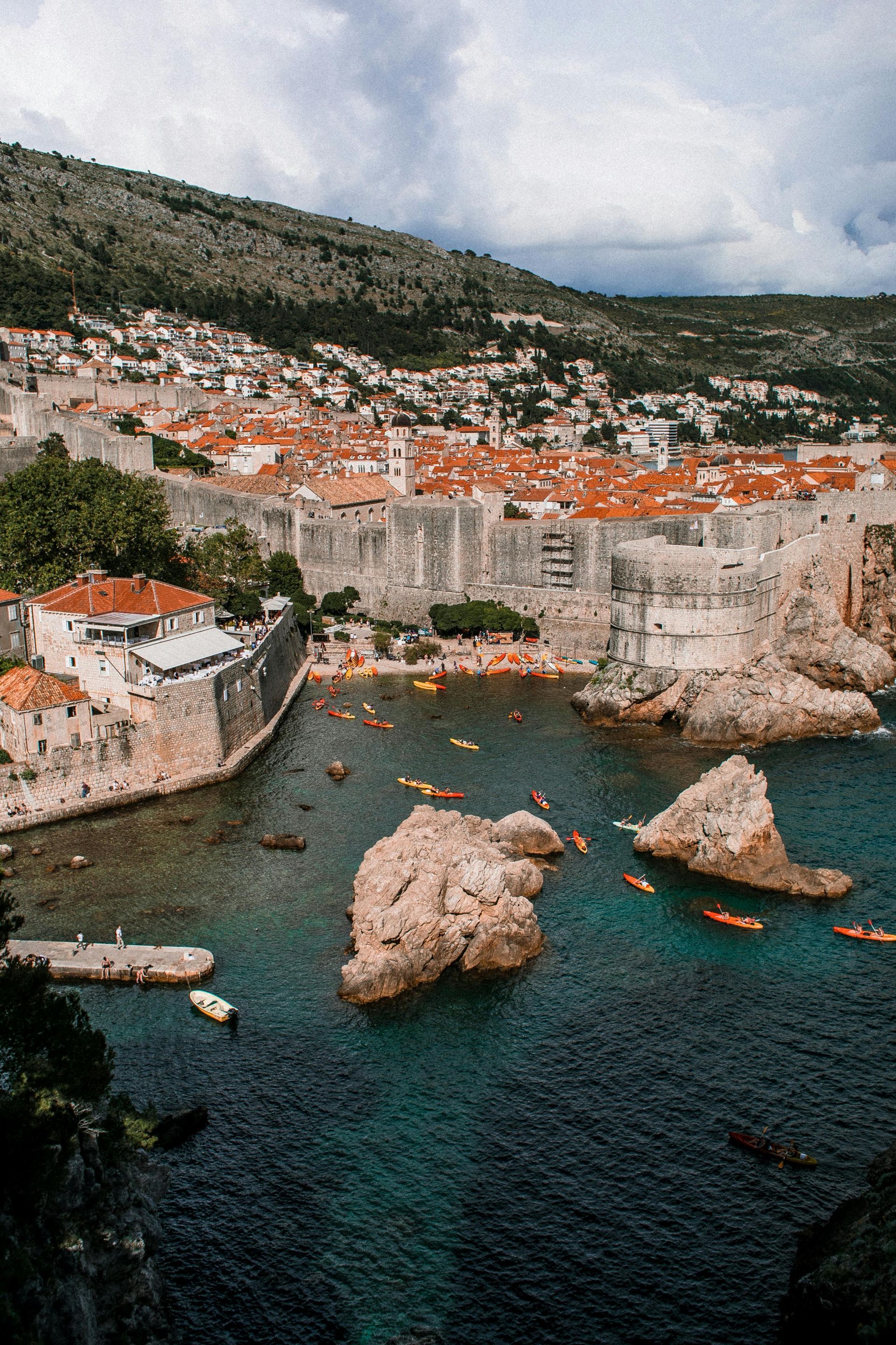 An aerial view of a small town next to a body of water in Dubrovnik, Croatia. 