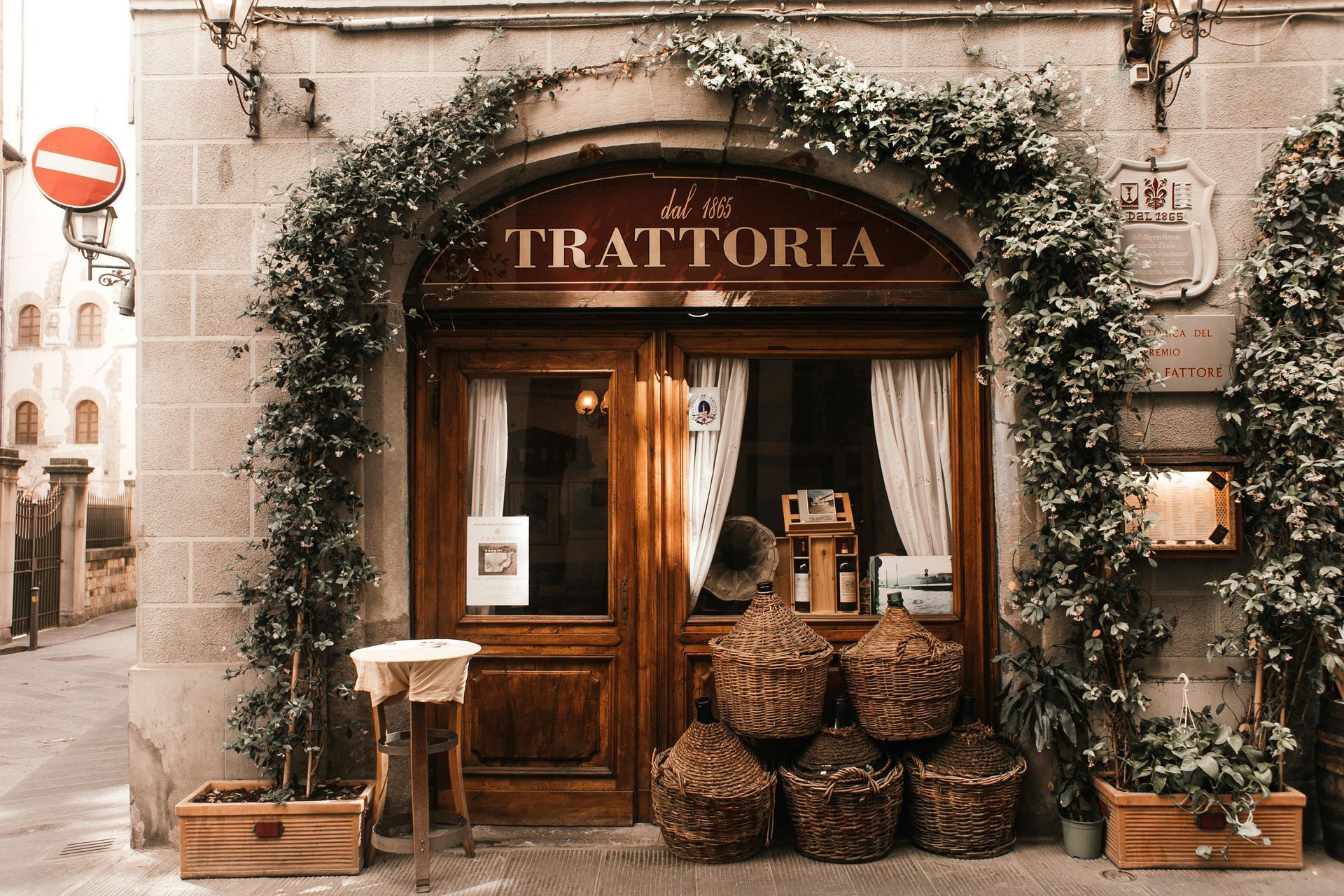 A restaurant with a sign that says trattoria on it in Florence, Italy.