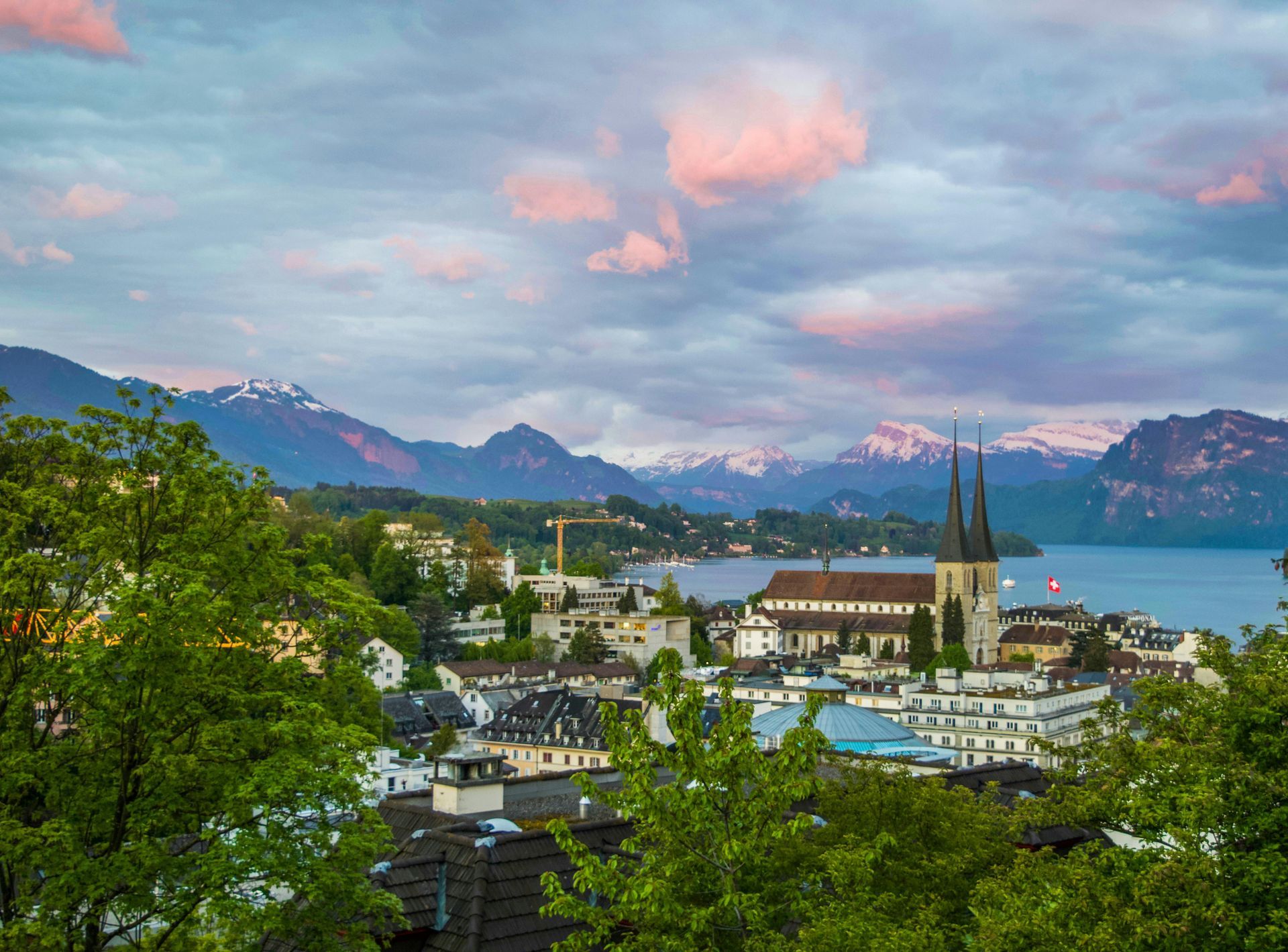 An aerial view of a city with mountains in the background and a lake in the foreground in Switzerland.