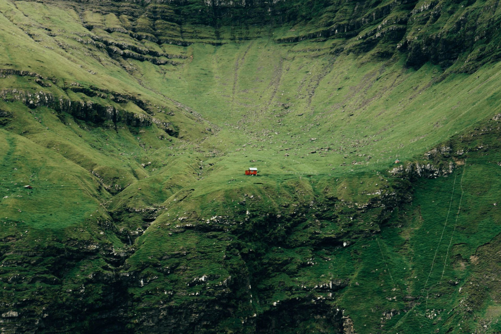 A small house is sitting in the middle of Ellidaey Island in Iceland.