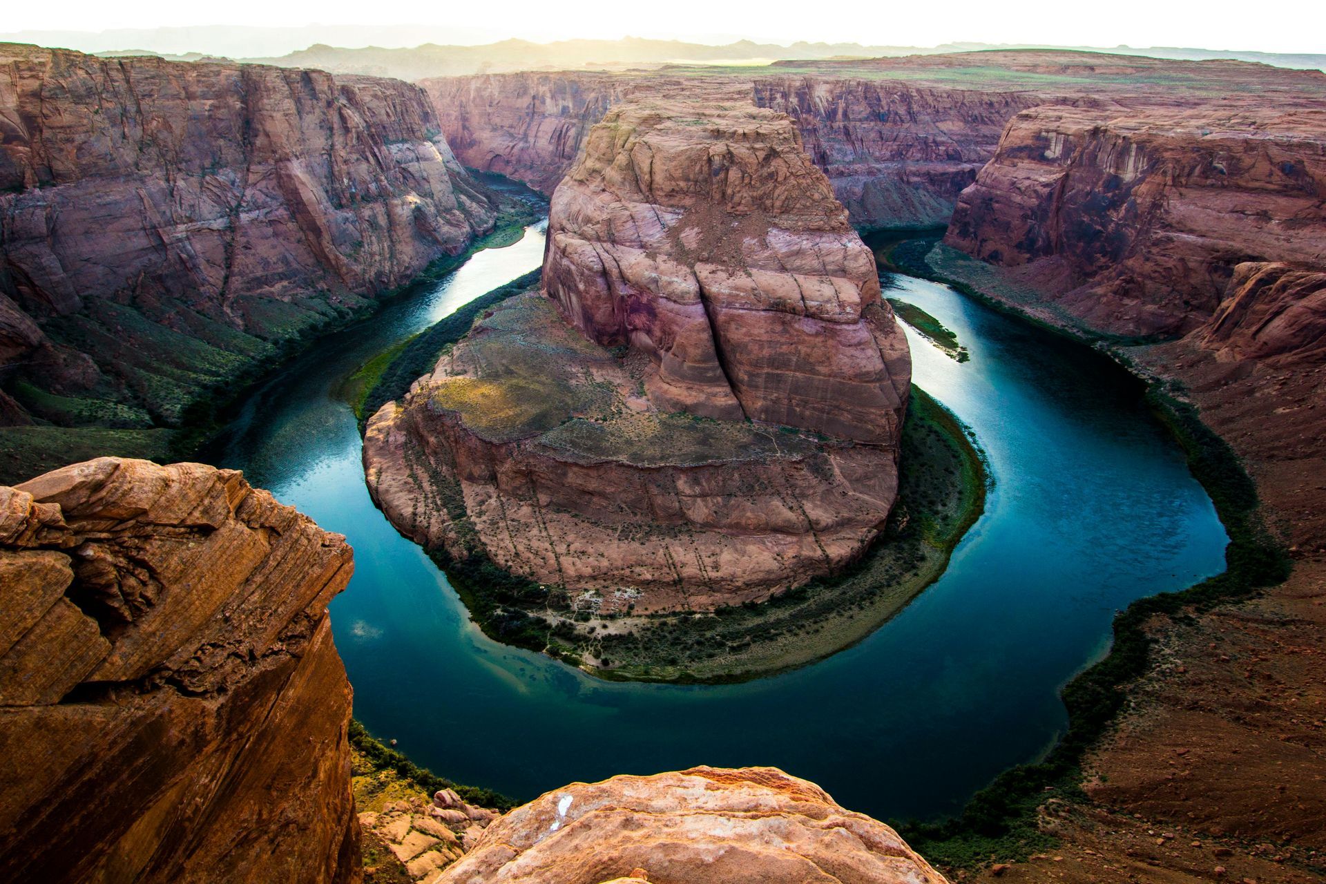 A river in the middle of a canyon surrounded by rocks at Horseshoe Bend in Arizona.