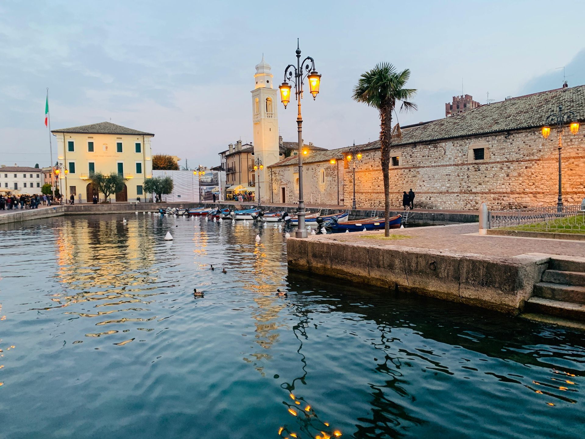 Lake Garda with a dock and buildings in the background in Italy.