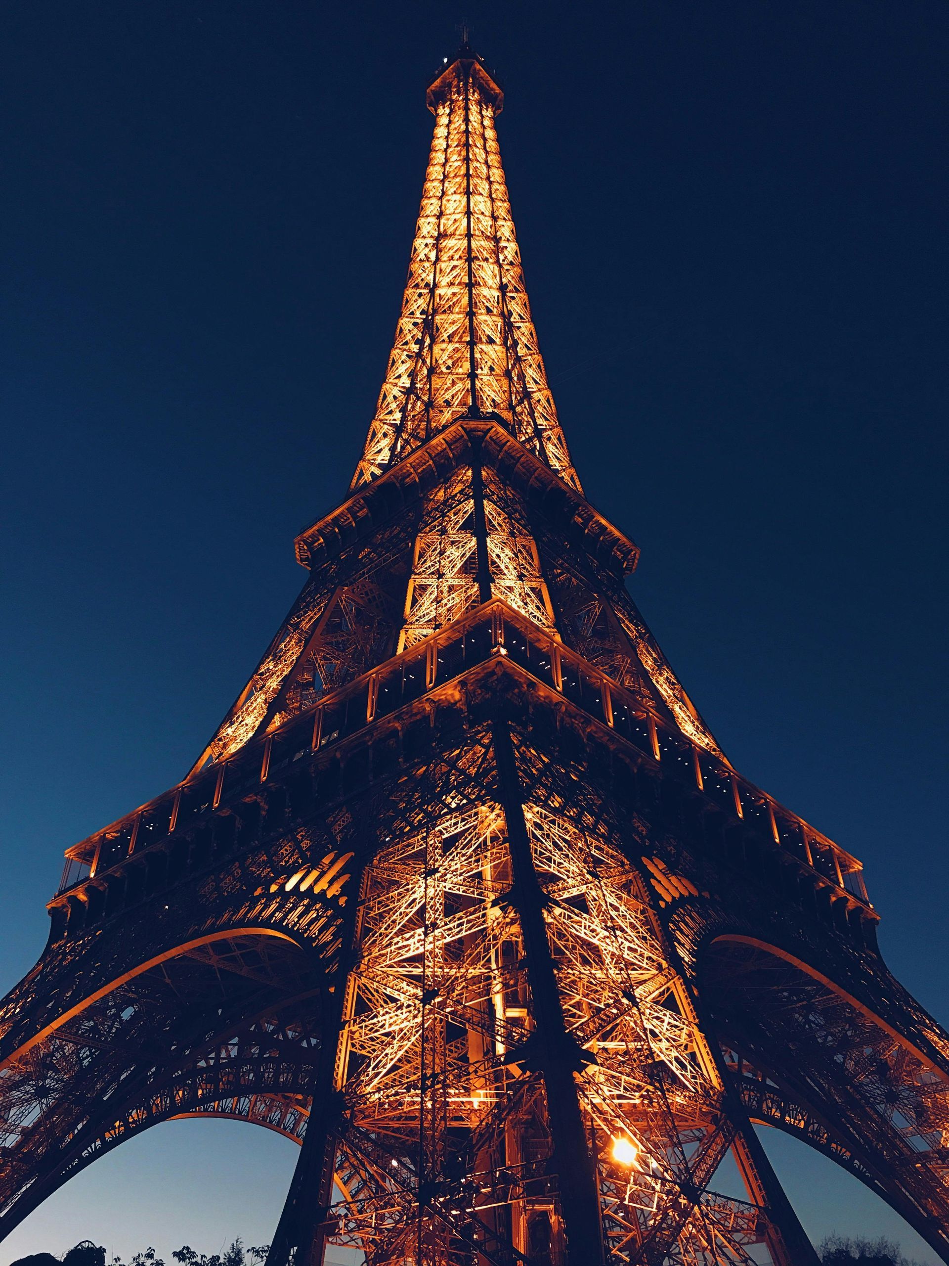 The eiffel tower is lit up at night in paris