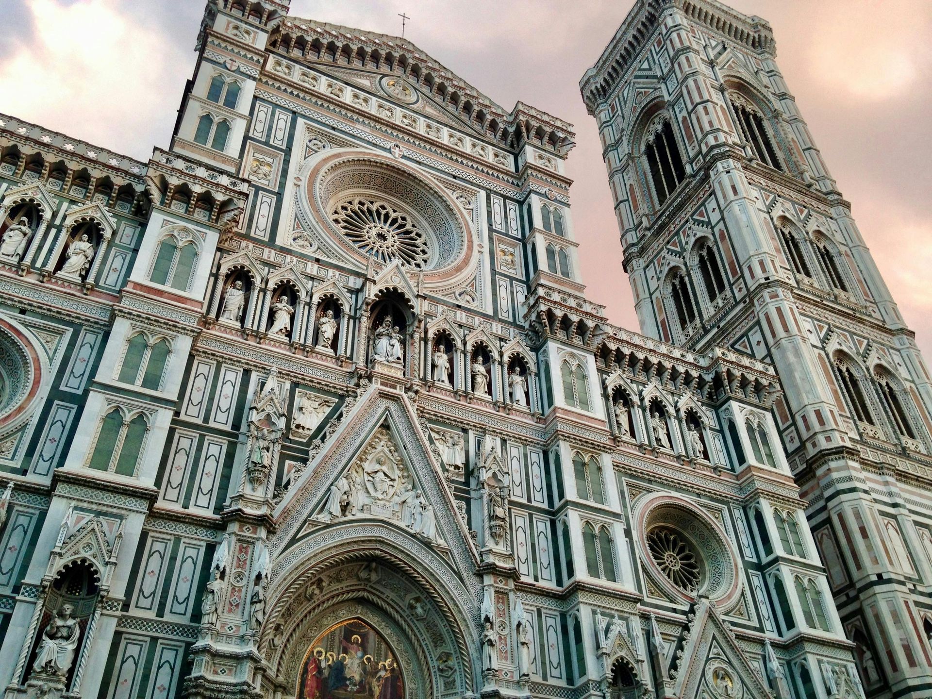 A large building with a clock tower on top of it in Florence, Italy.