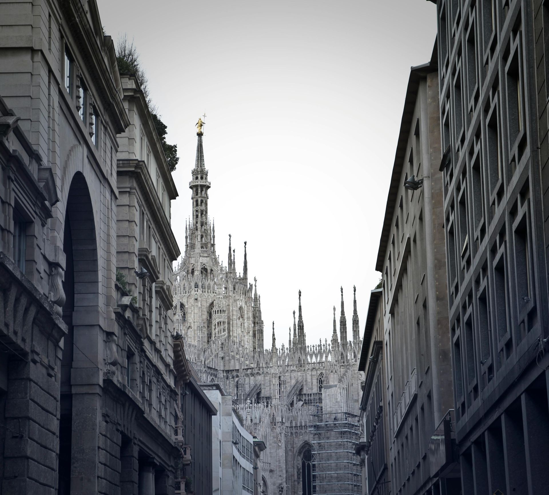 A city street with the Duomo di Milano in the background in Milan, Italy.