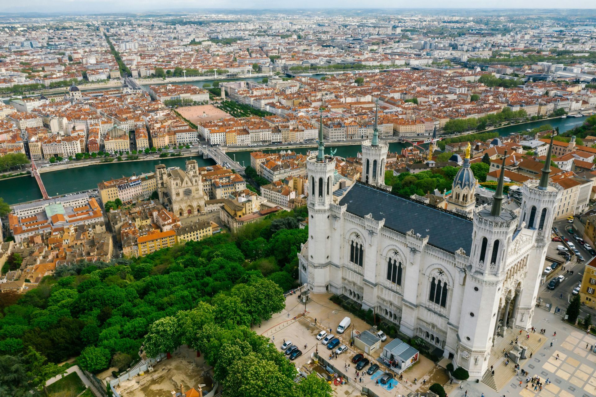 An aerial view of a large white building in the middle of a city in Lyon, France.