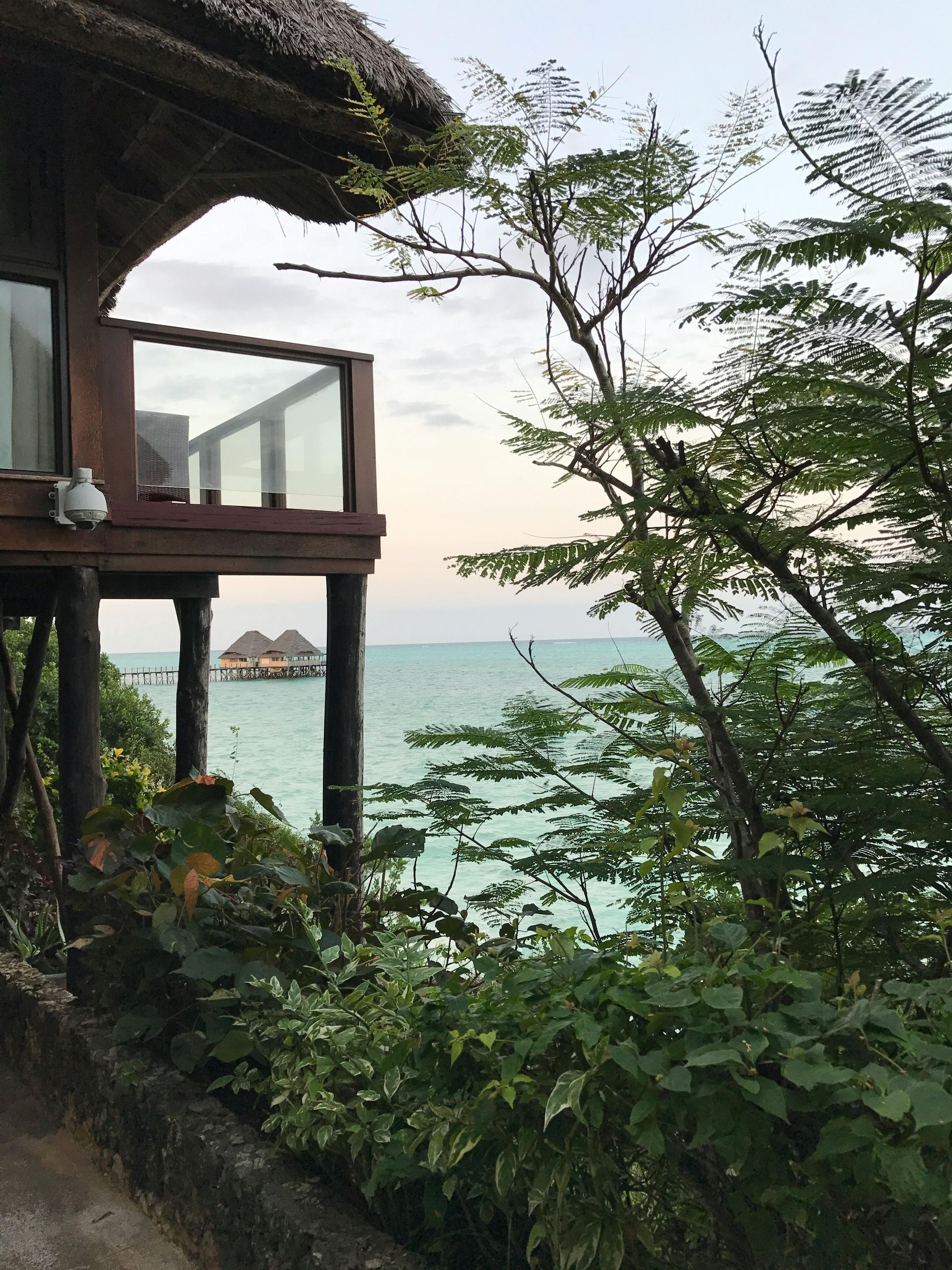 A thatched hut with a balcony overlooking the ocean in Zanzibar island in Tanzania, Africa.