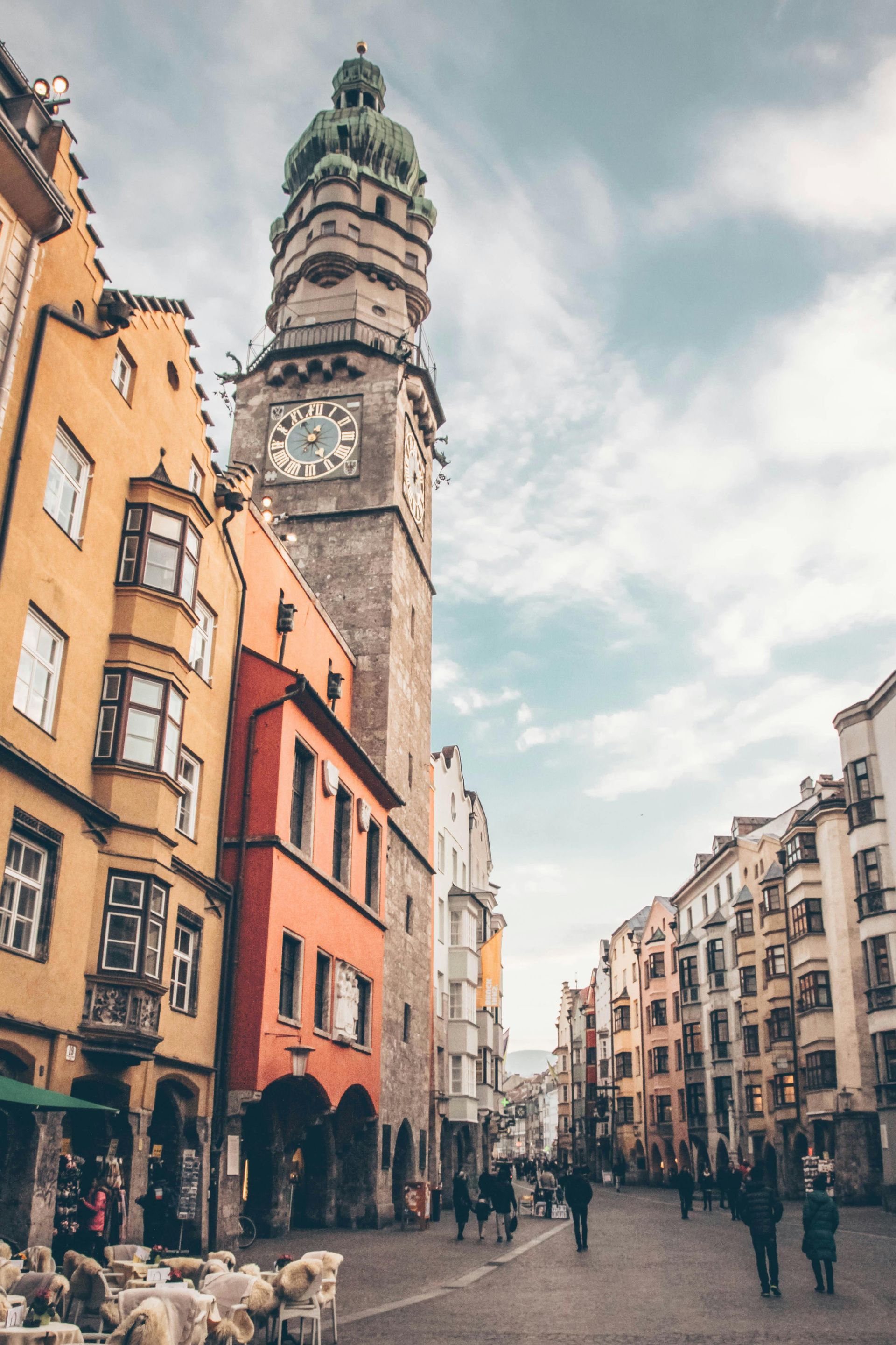 A clock tower in the middle of a city surrounded by buildings in Switzerland.