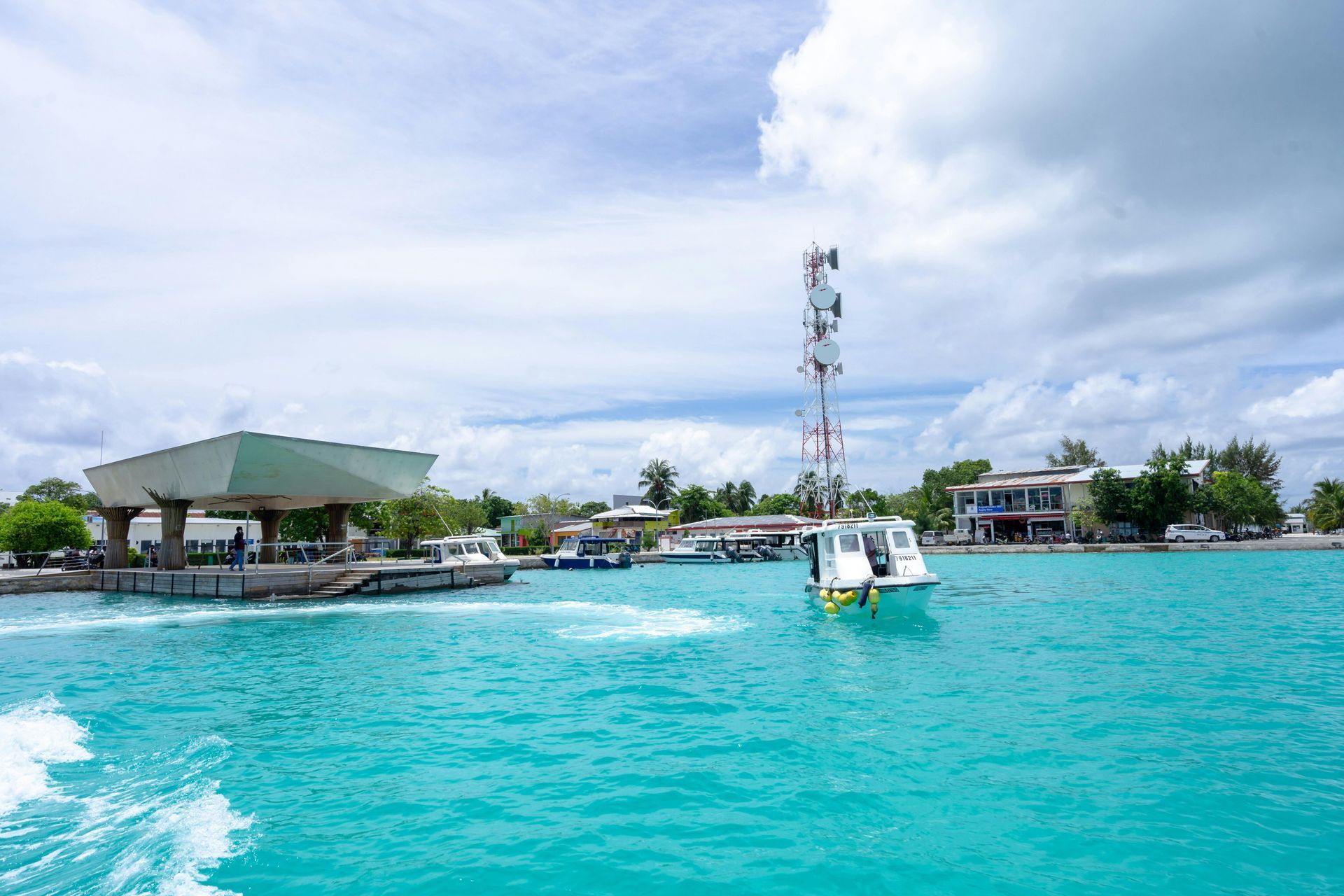 A boat is floating on top of a large body in the Caribbean.