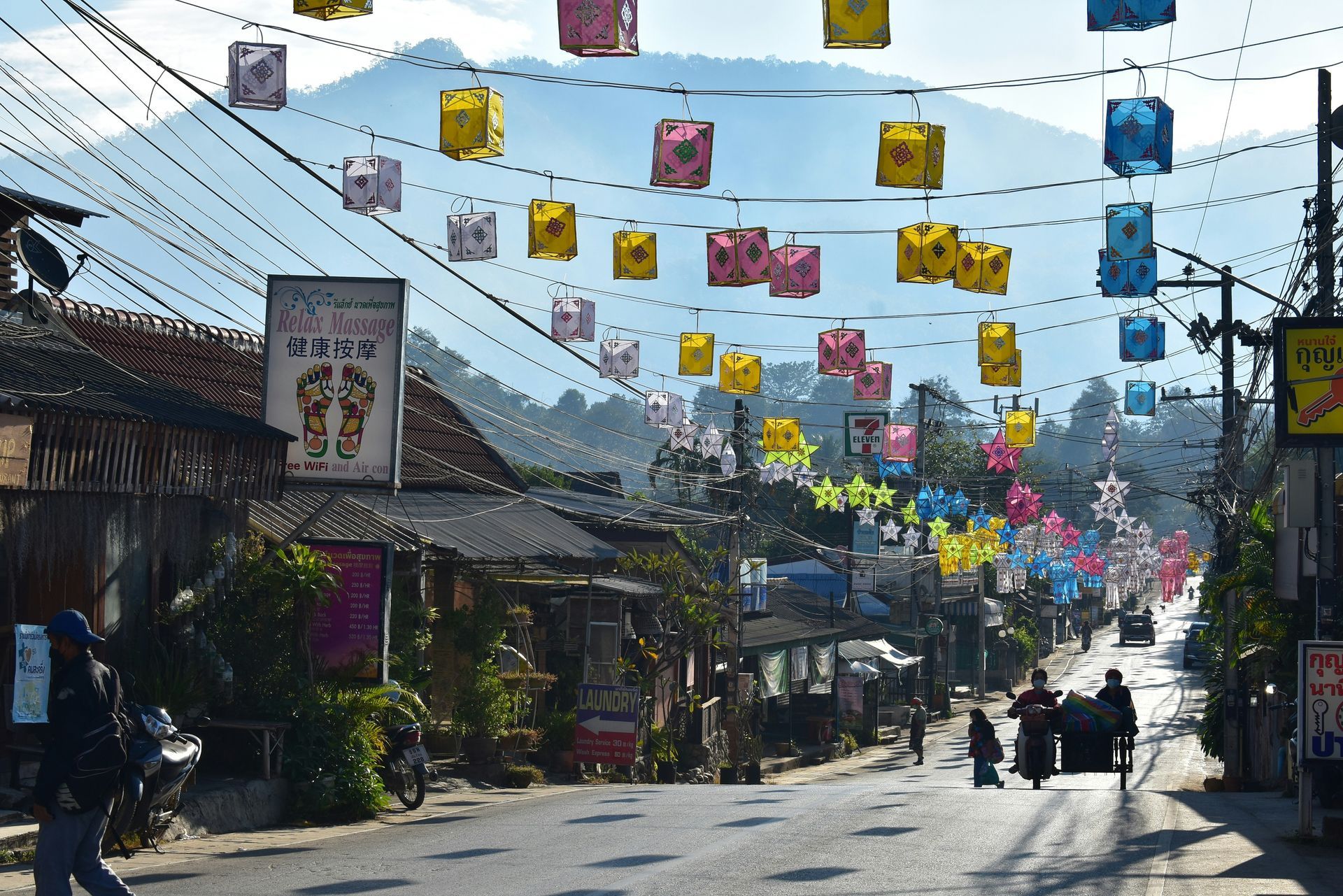 A street with many lanterns hanging from the strings in Pai, Thailand.
