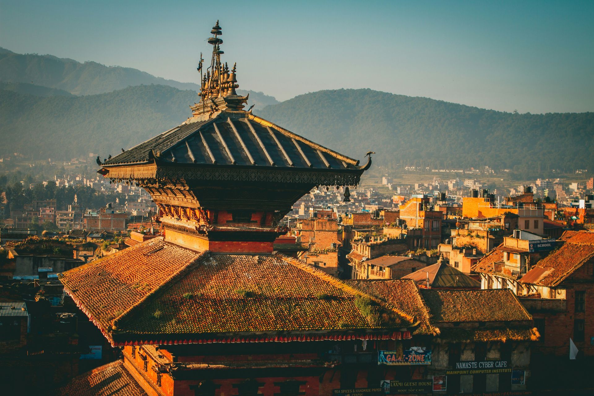 Rooftop view of a Nepalese temple with ornate pagoda roof, overlooking Bhaktapur, Nepal.