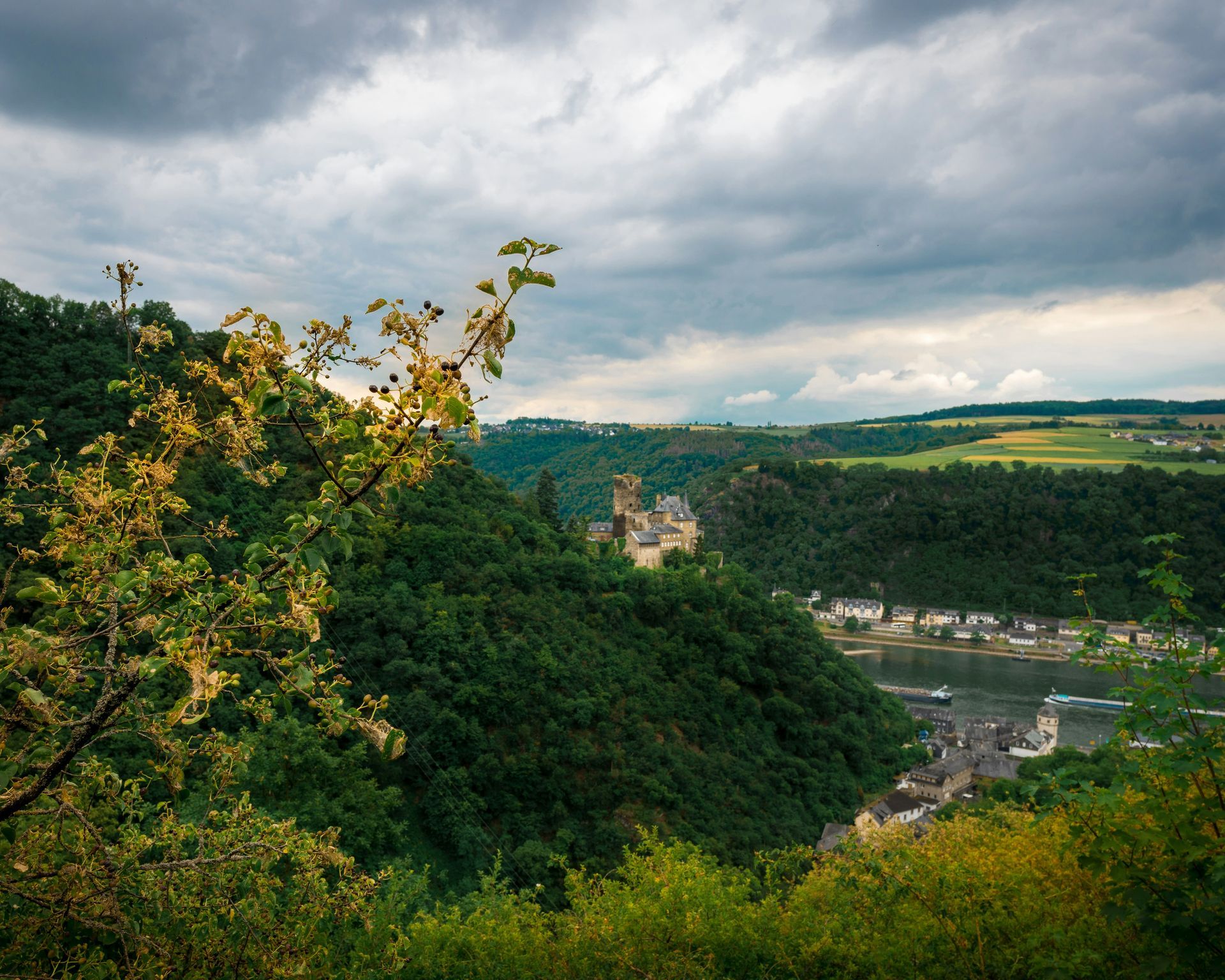 Castle on a forested hill overlooking the Rhine Gorge and the town of Sankt Goarshausen, Germany.
