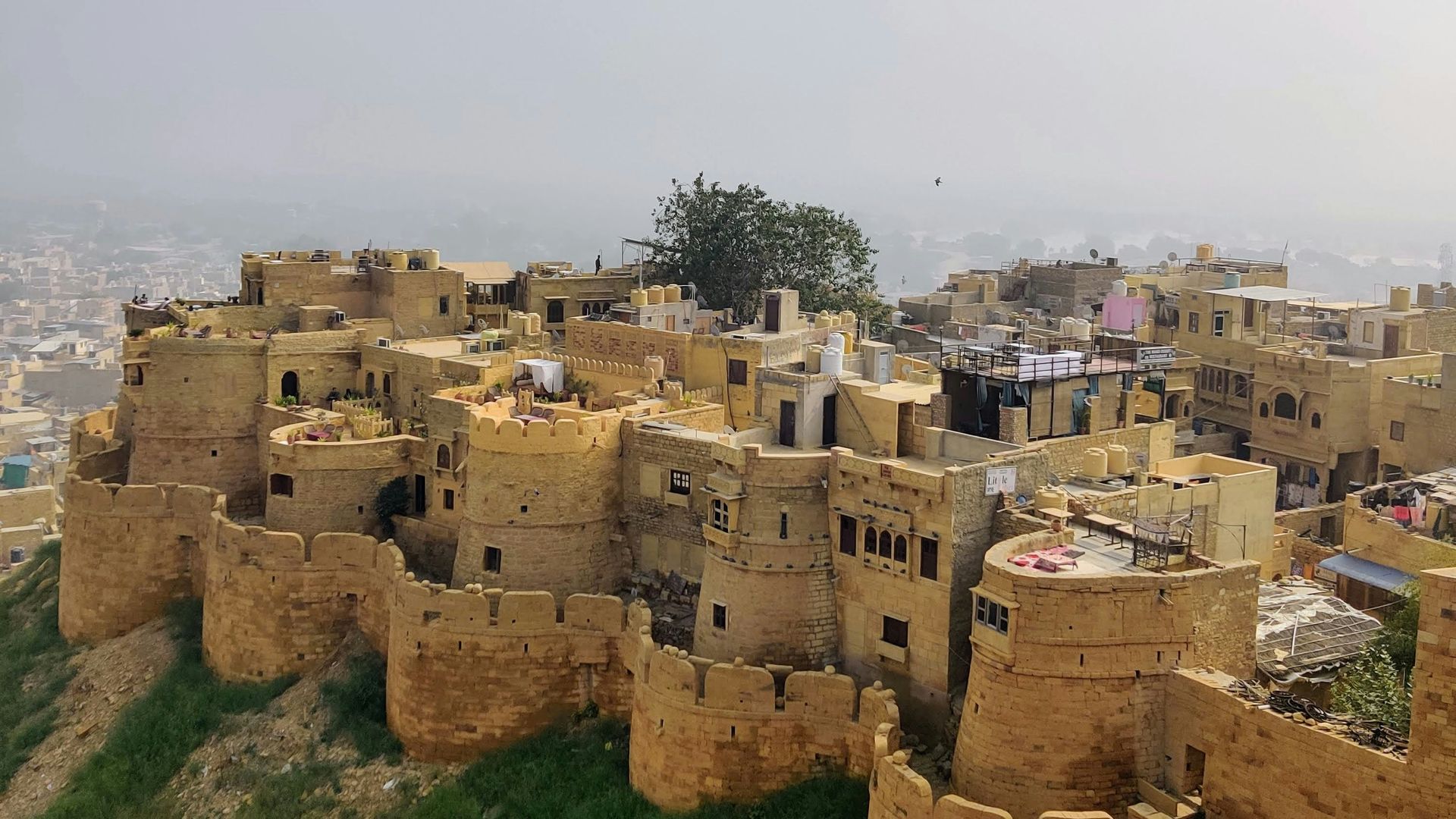 Yellow sandstone fort complex on a hill, overlooking Jaisalmer, India.
