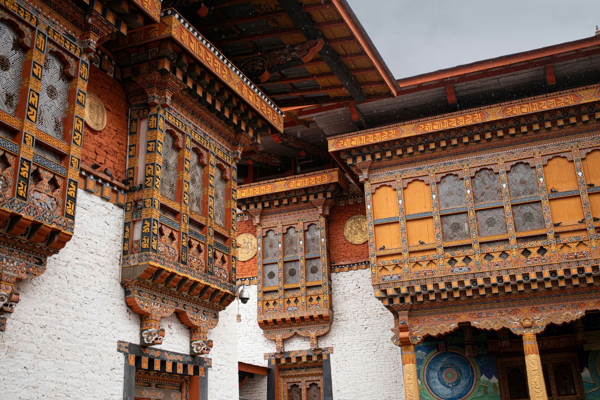 Ornate wooden balconies on white building of Punakha Dzong in Punakha, Bhutan.