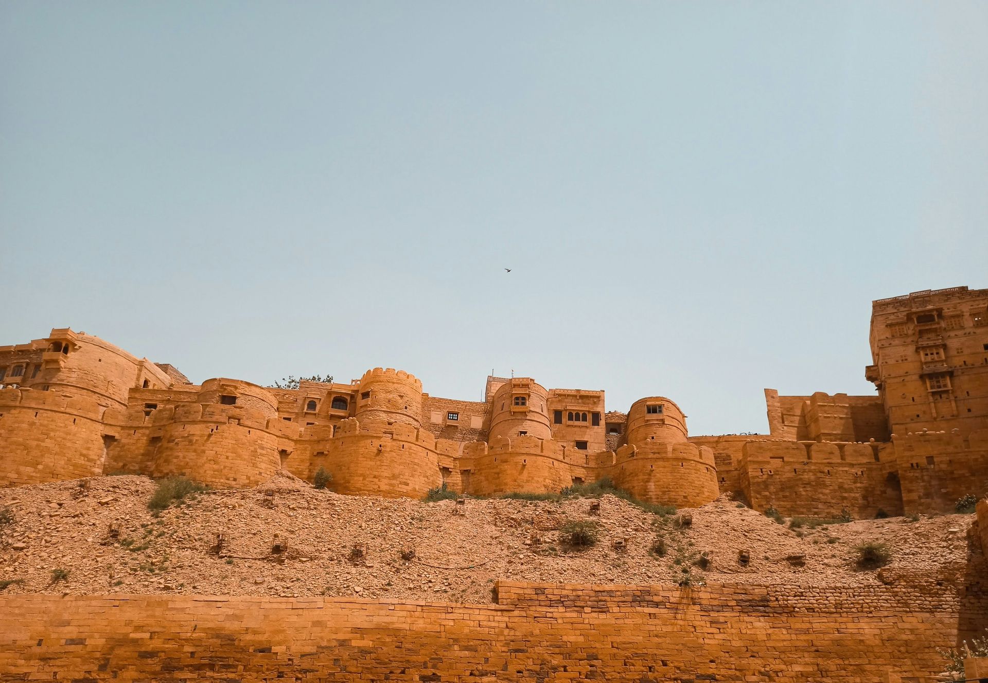 Ancient sandstone fort against a clear blue sky, Jaisalmer, India.