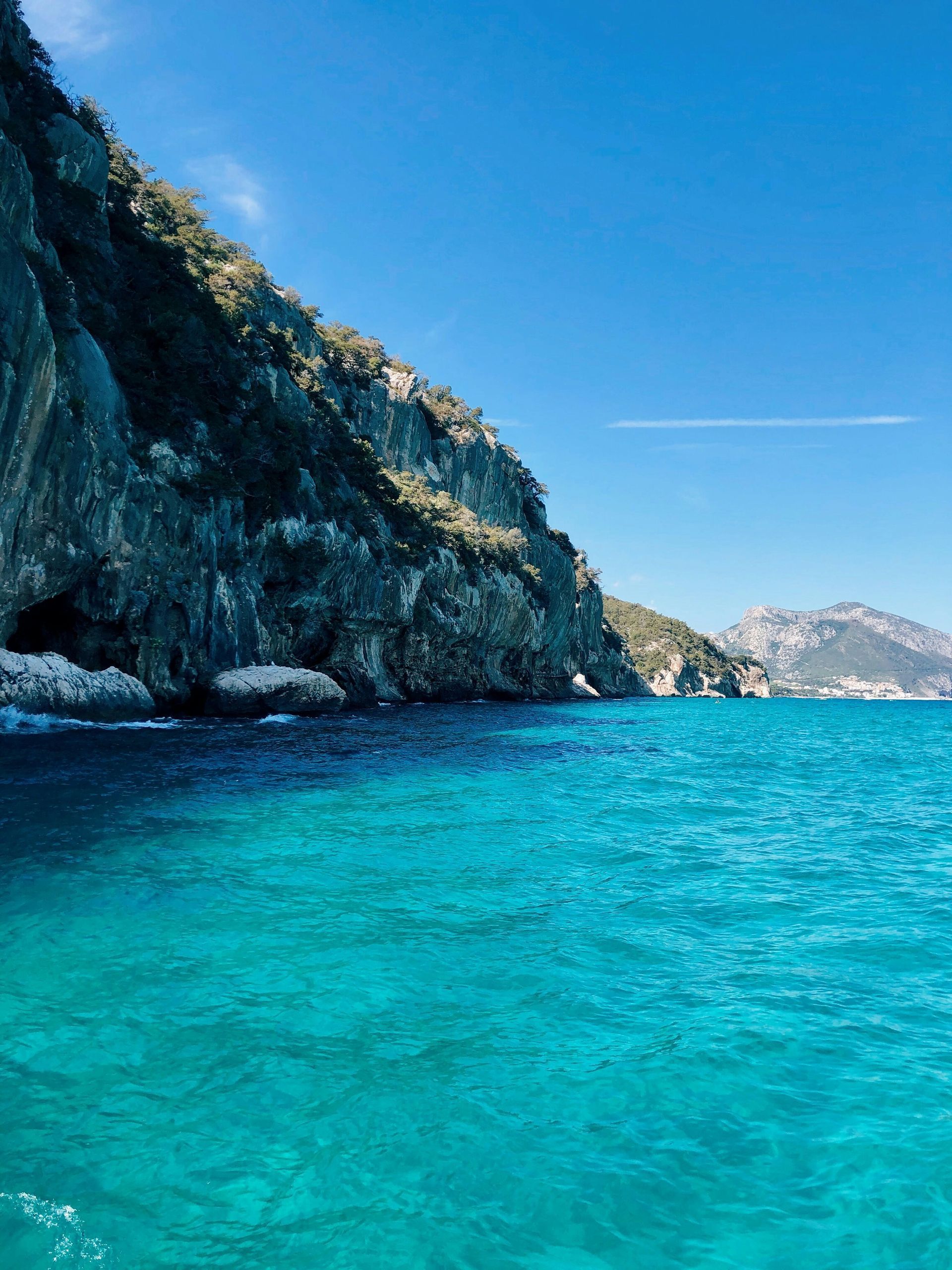 A large body of water with mountains in the background in Sardinia, Italy.