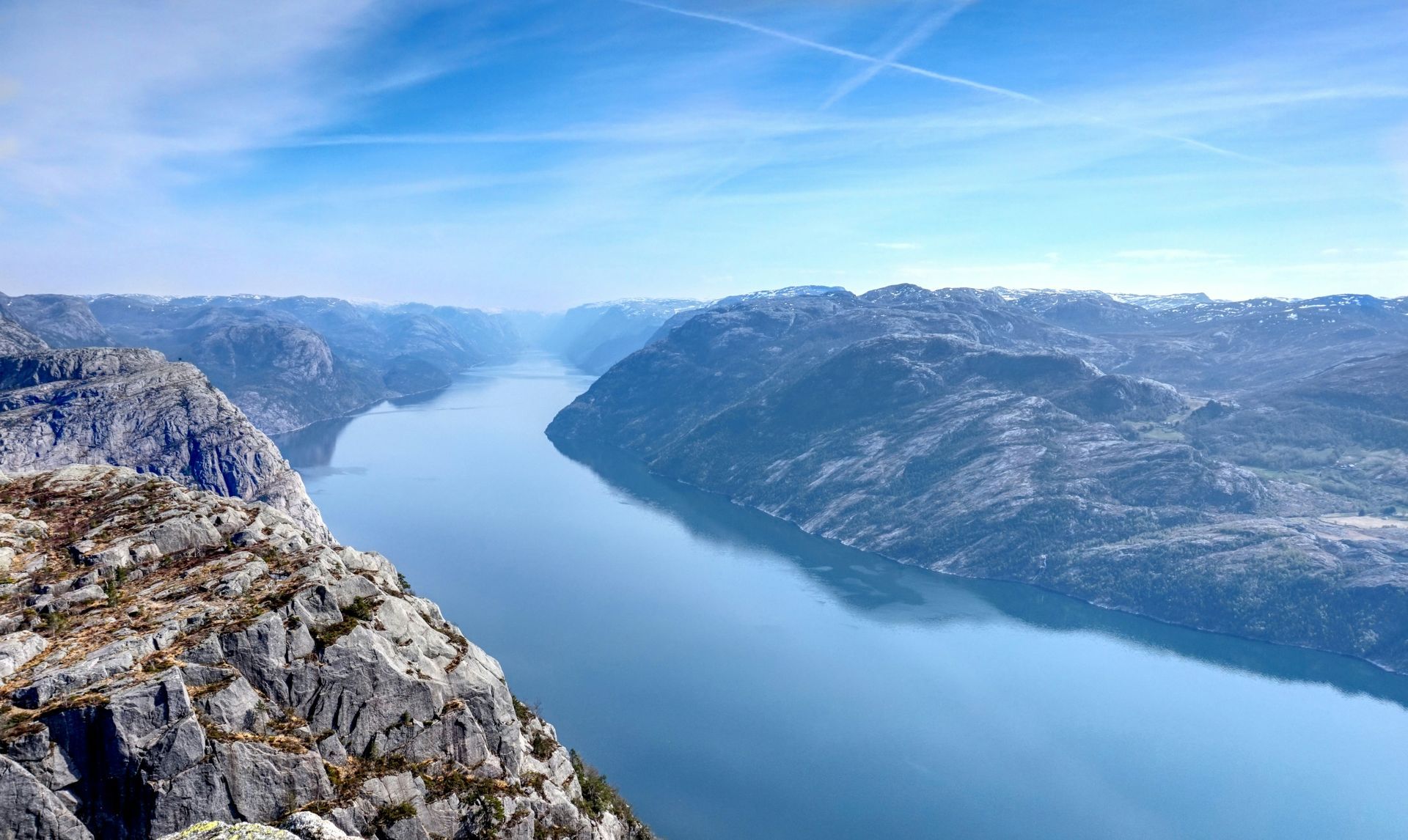 Lysefjord between rocky mountains under a clear sky in Norway.