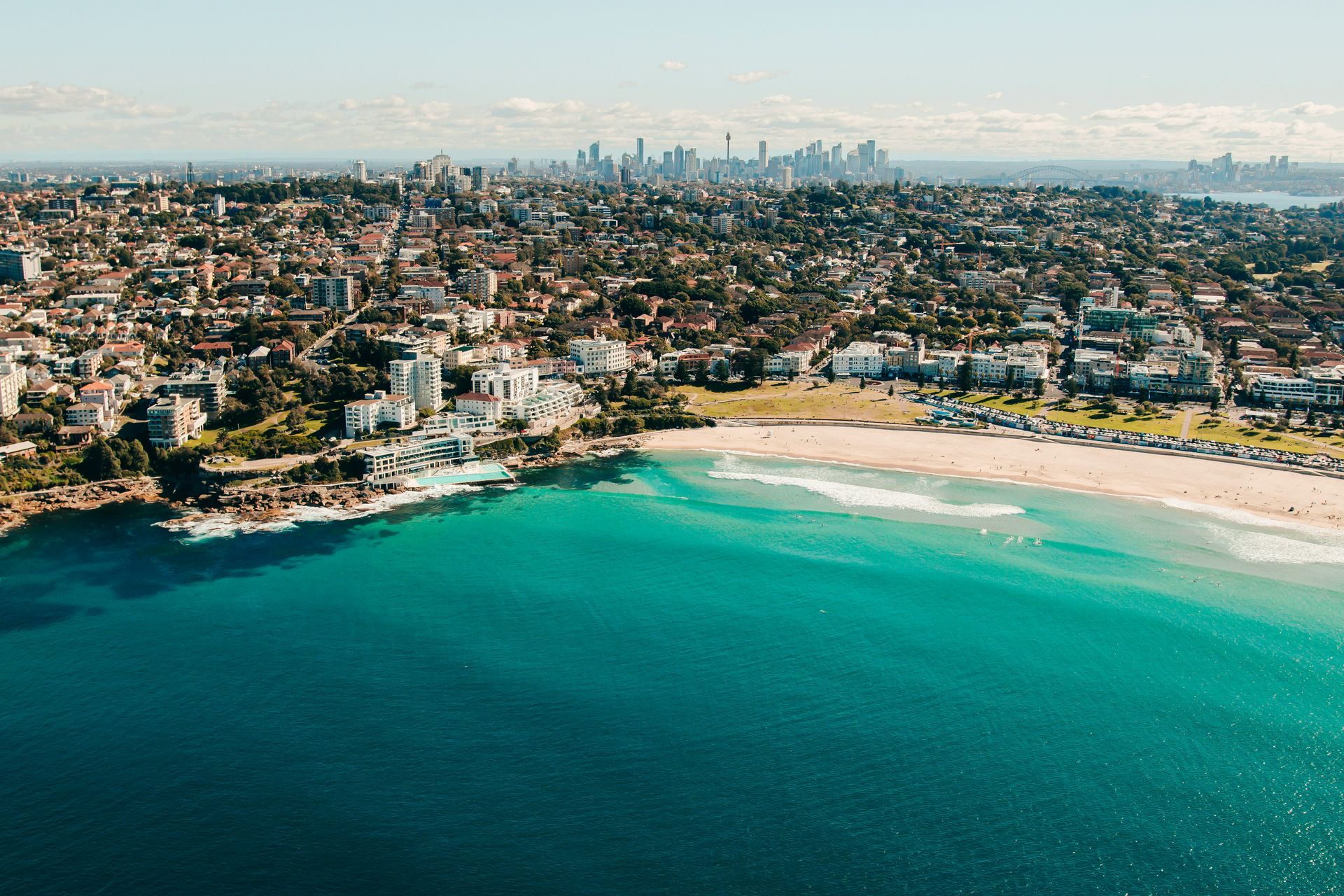 An aerial view of Bondi Beach with a city in the background in Sydney, Australia. 