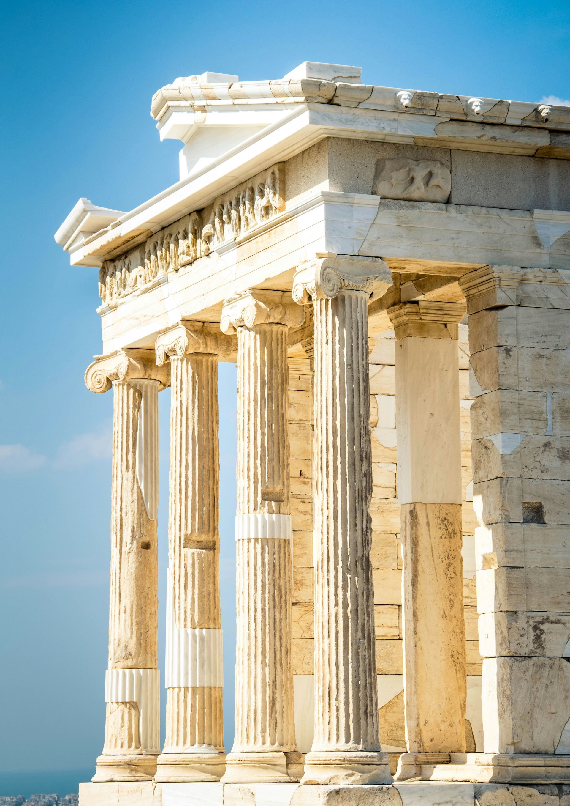 The Parthenon with columns and a blue sky in the background in Athens, Greece.